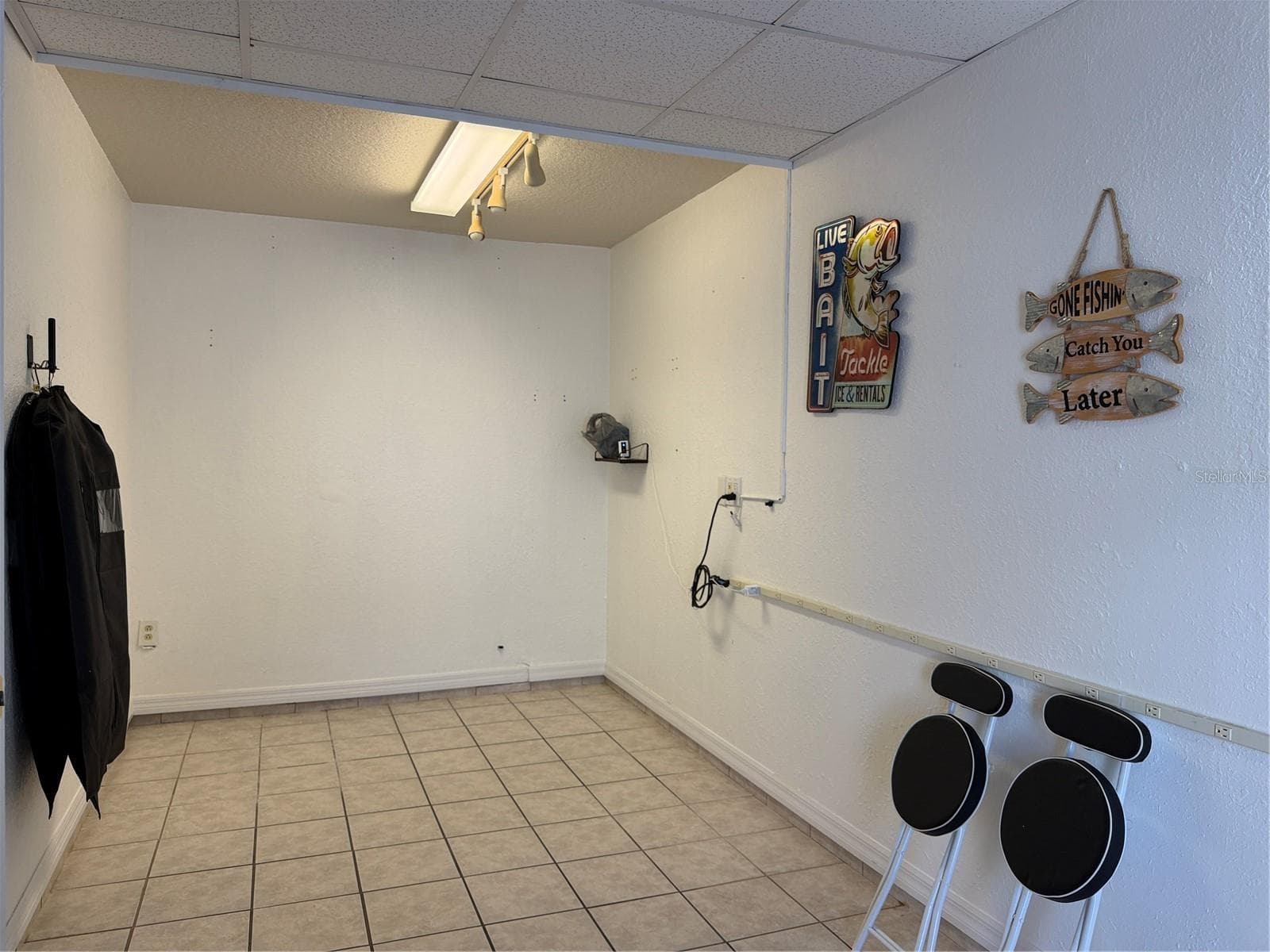 Bonus room in garage has elect plug strip on wall, and tile flooring - 2311 OASIS DR, LAND O LAKES
