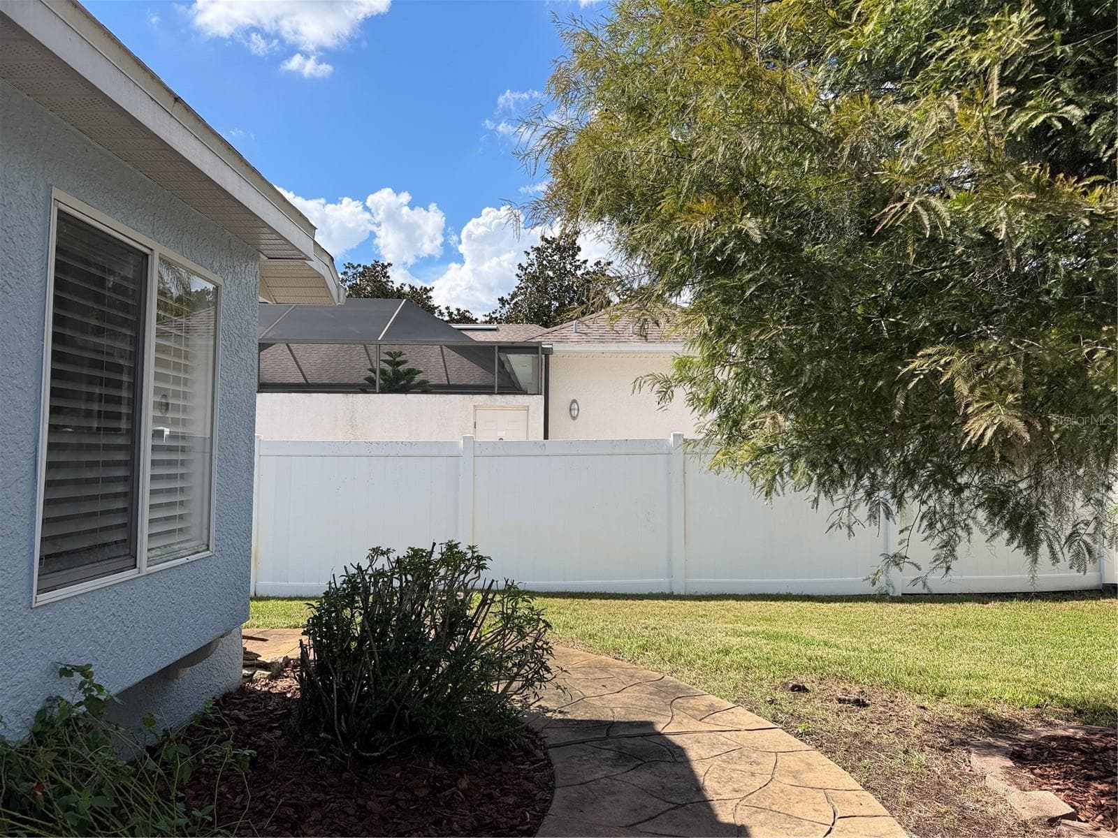 Sidewalk heading West to the Southwest side of home. - 2311 OASIS DR, LAND O LAKES