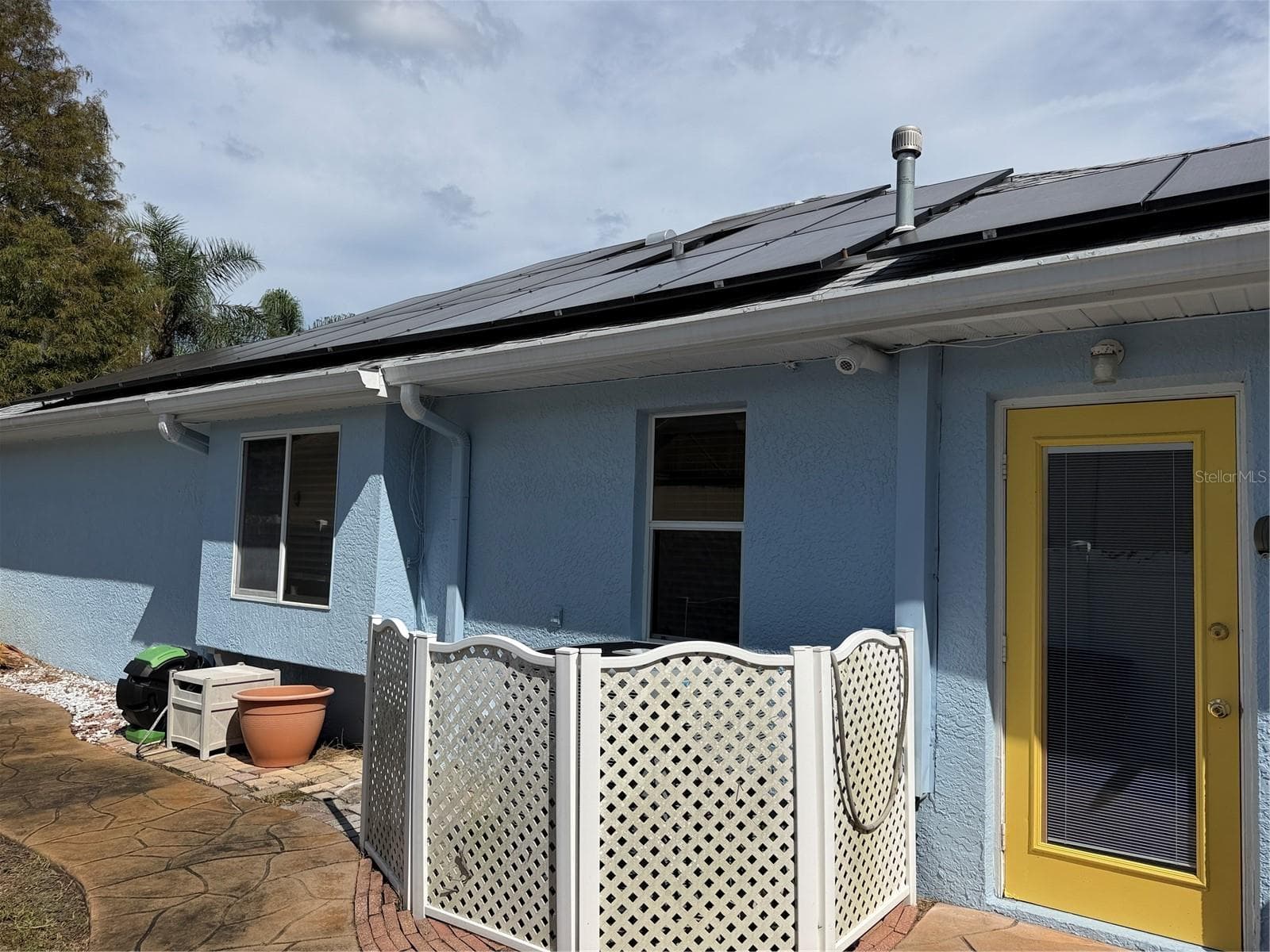 Behind the latest is the air conditioning system - 2311 OASIS DR, LAND O LAKES