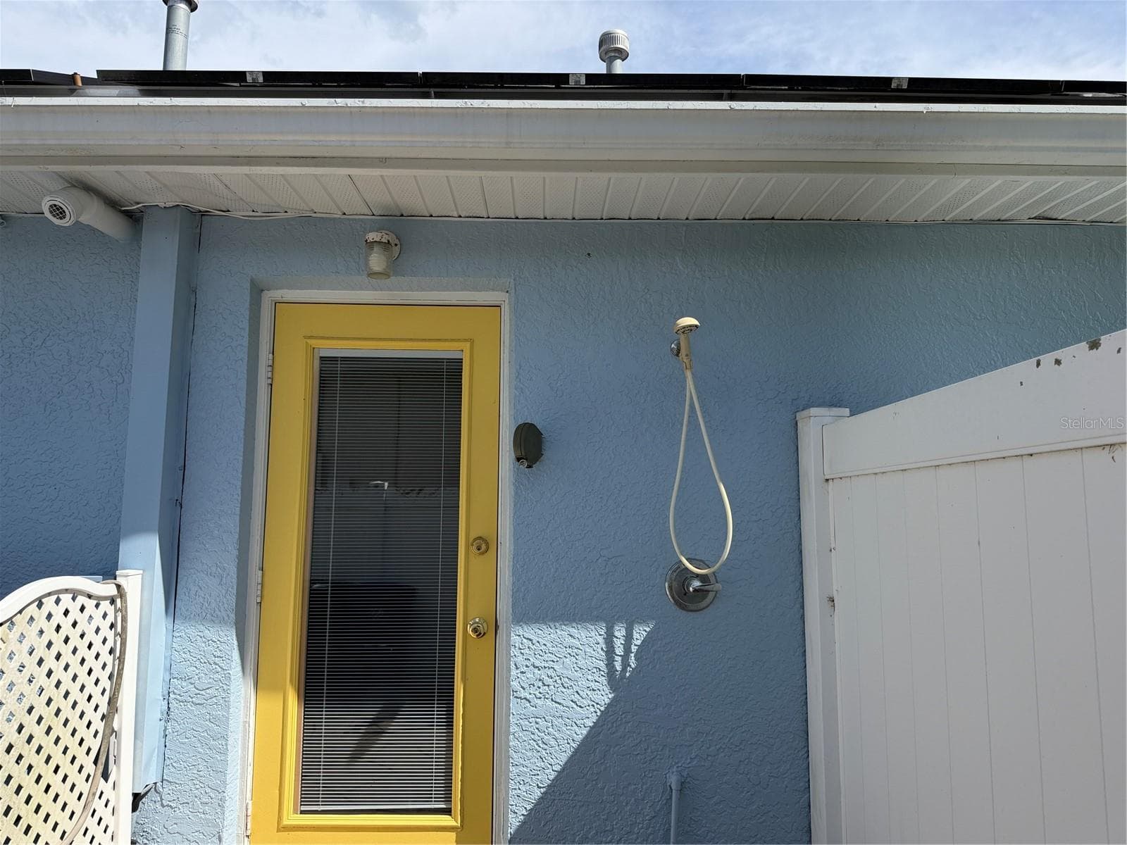 Outdoor shower to the right of the door that leads to bonus room. Tankless water heater in house - 2311 OASIS DR, LAND O LAKES