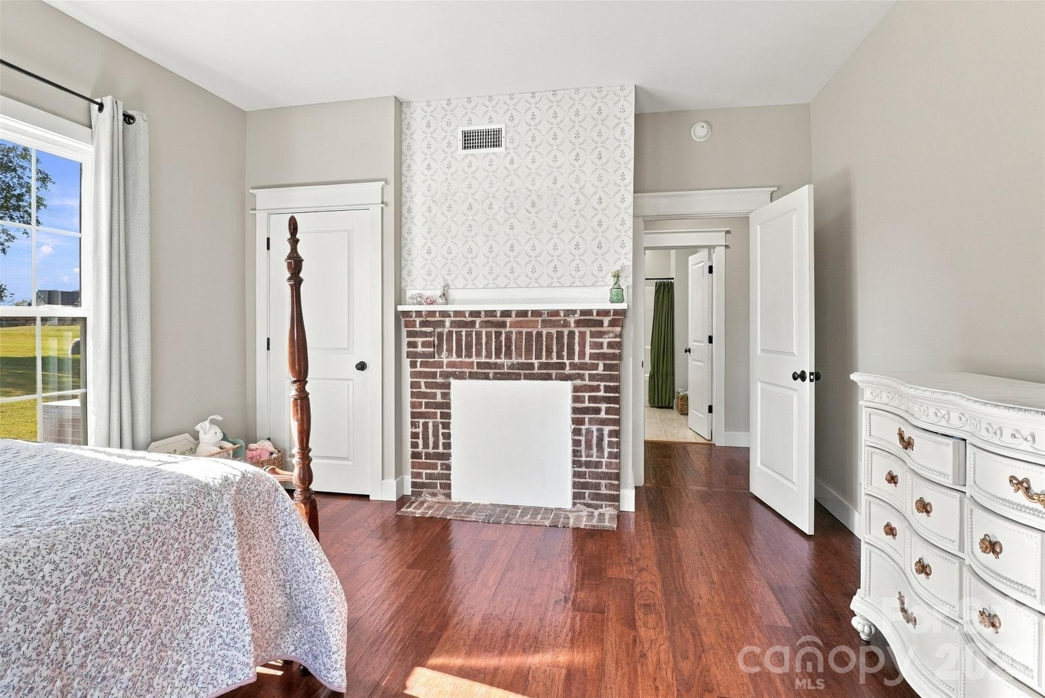 Main floor Bedroom #2 with closet and old fireplace brick surround. - 3098 Irene Bridge Highway, Hickory Grove