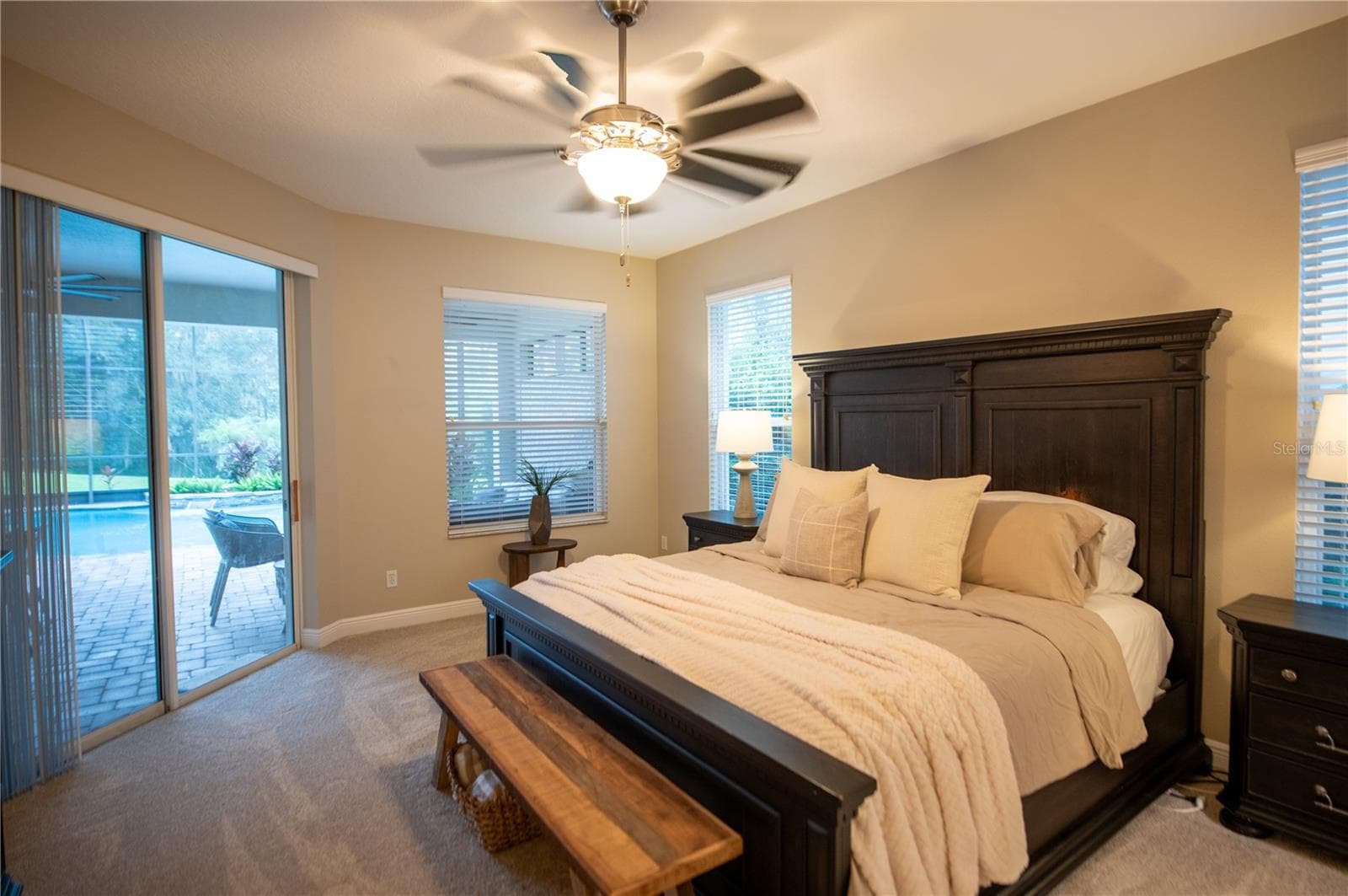 primary bedroom with door to lanai & pool - 14038 EDEN ISLE BLVD, WINDERMERE