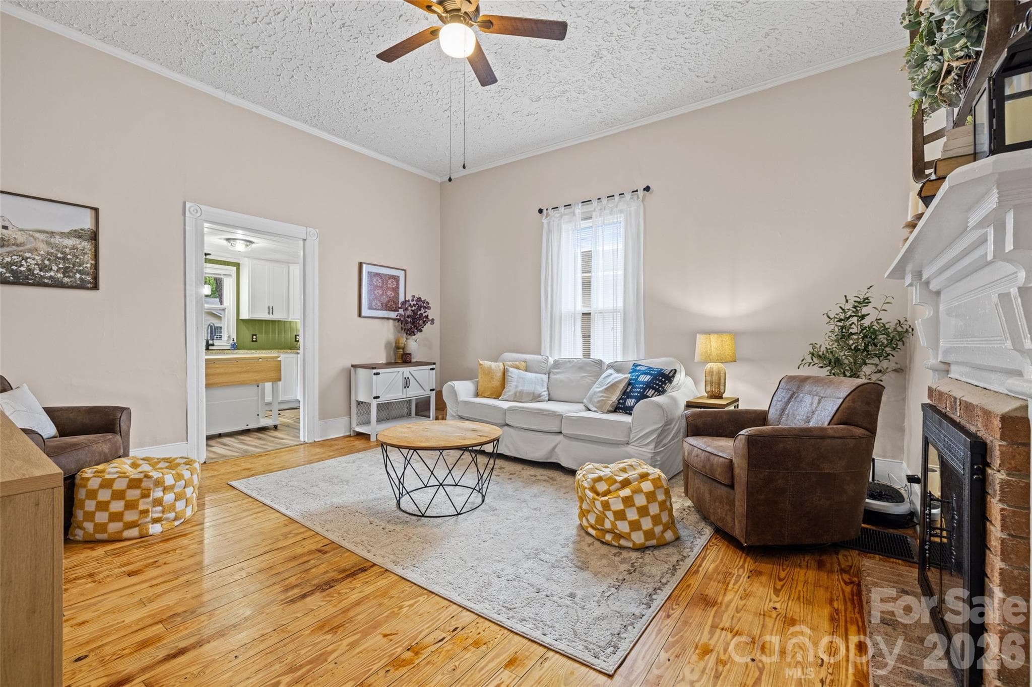 Inviting living room featuring refinished hardwood floors, tall ceilings, and plenty of space for entertaining. - 231 E Jefferson Street, York