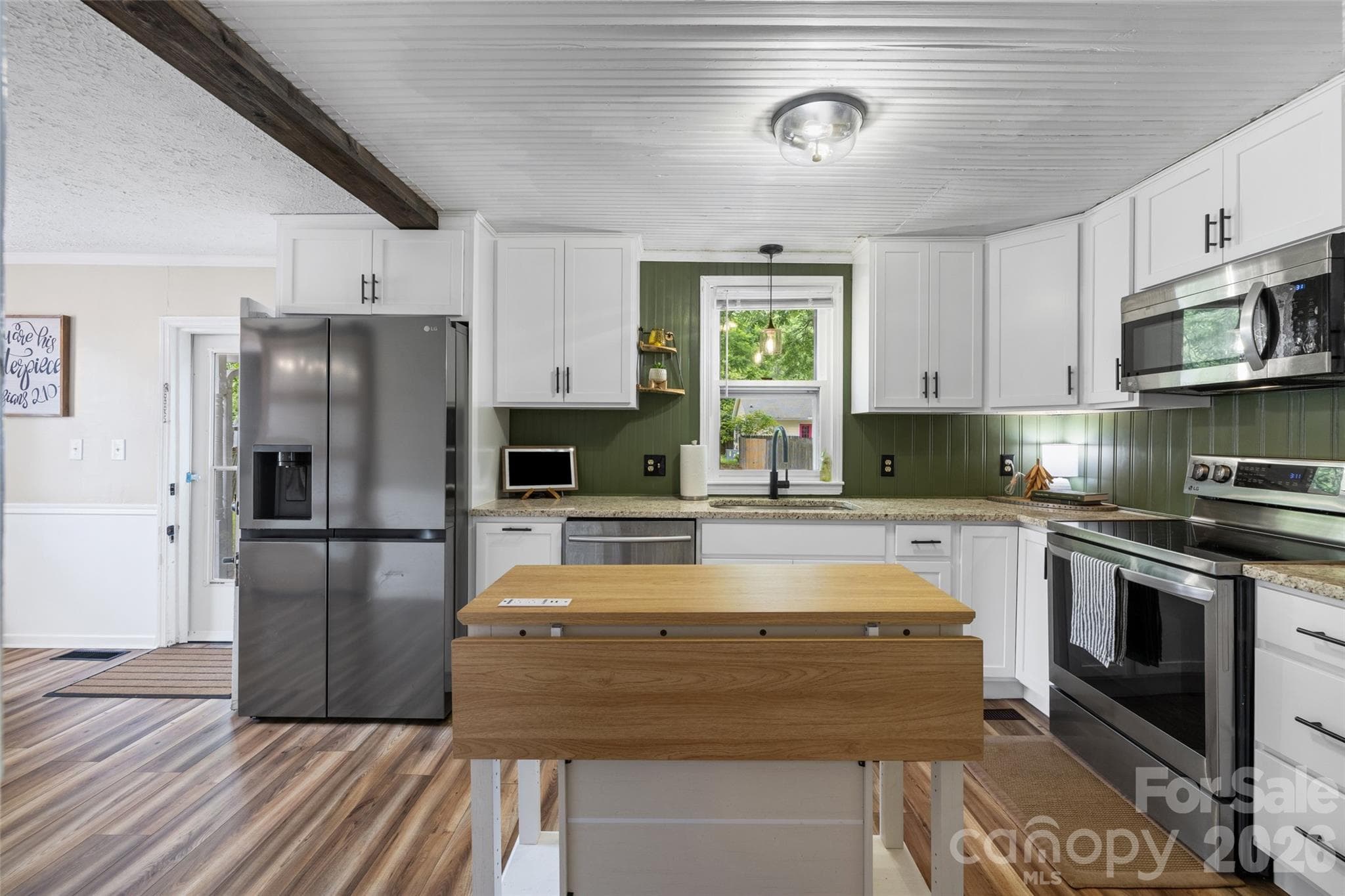 Beautifully remodeled kitchen featuring new cabinetry, countertops, stainless steel appliances, and a spacious center island. - 231 E Jefferson Street, York