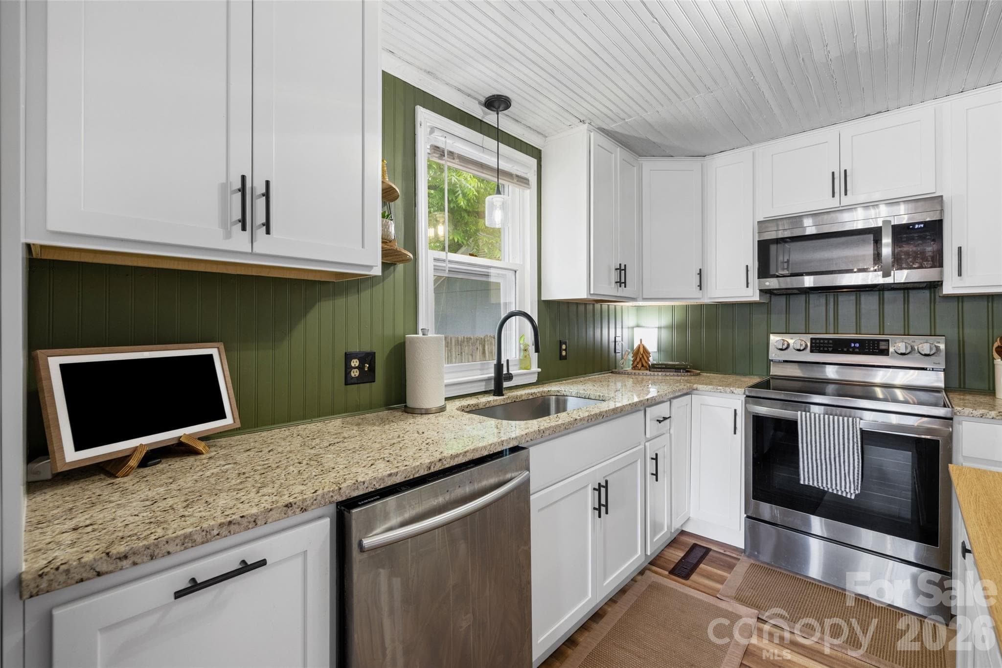 Stylish kitchen with generous cabinetry, updated countertops, and stainless steel appliances. - 231 E Jefferson Street, York