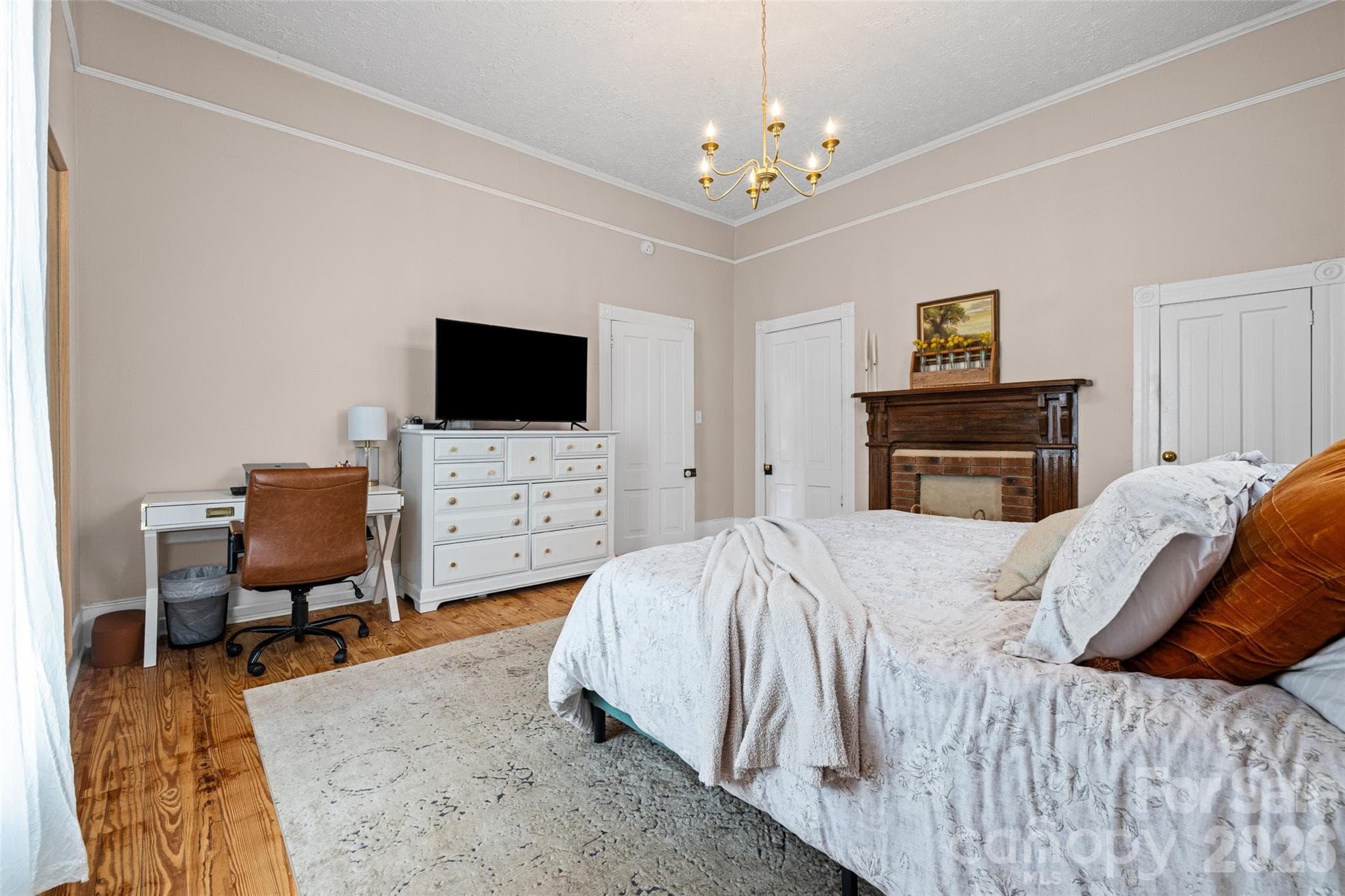 Historic charm shines through with a decorative fireplace, hardwood floors, and elegant architectural details. - 231 E Jefferson Street, York