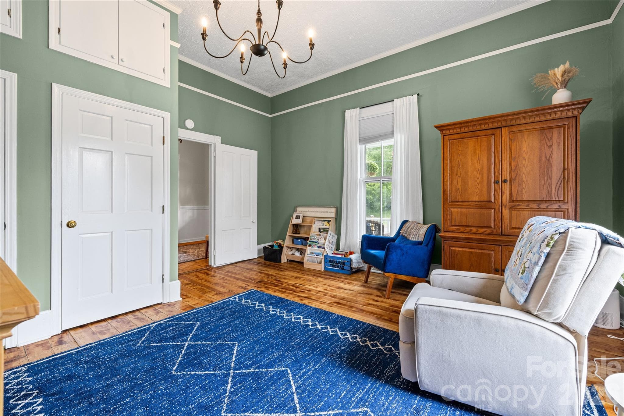 Bright secondary bedroom featuring refinished hardwood floors, tall ceilings, and beautiful natural light. - 231 E Jefferson Street, York