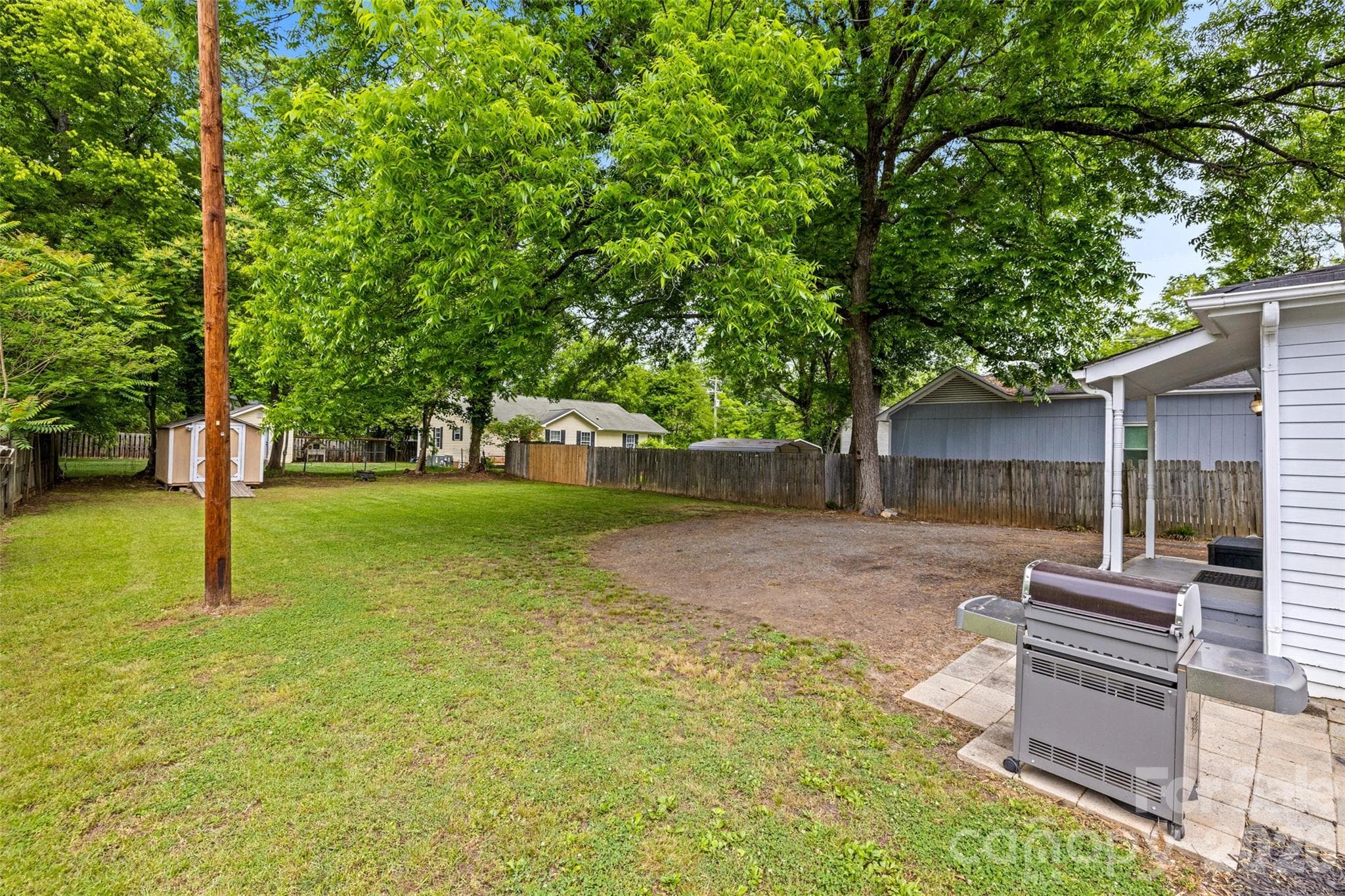 Generous outdoor space with mature trees, a fenced yard, and room to make it your own. - 231 E Jefferson Street, York