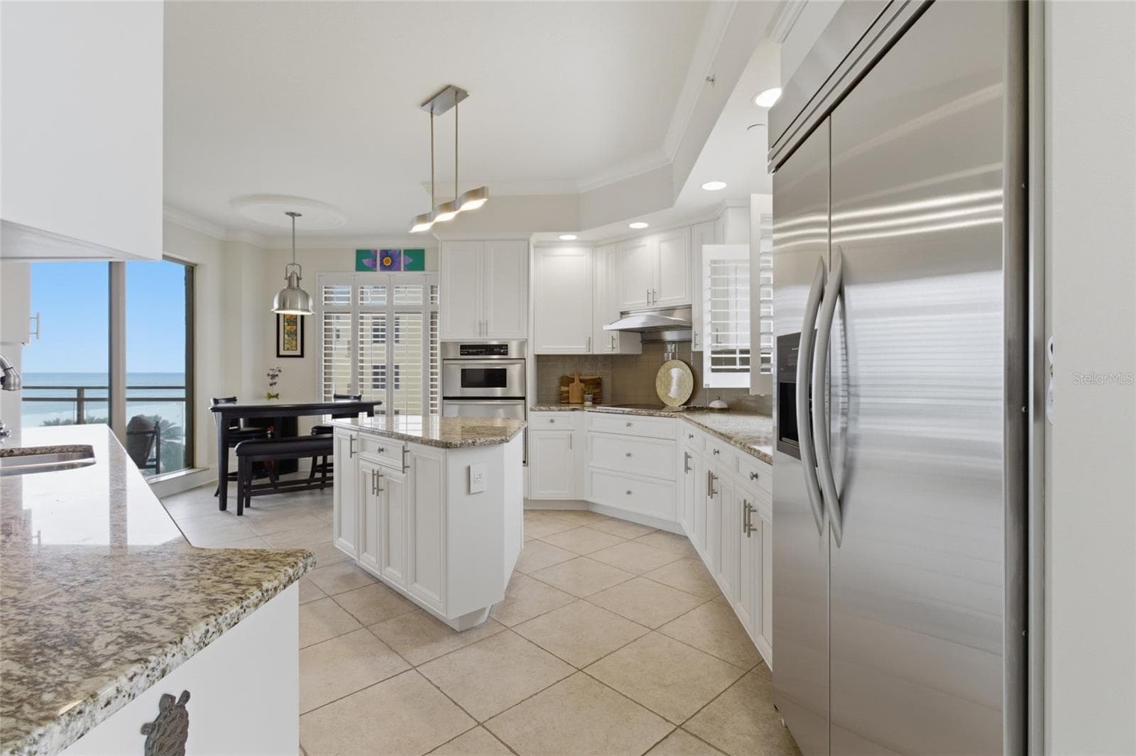 Walking from dining room to kitchen. Views on both the right and left! - 11 BAYMONT ST #608, CLEARWATER BEACH