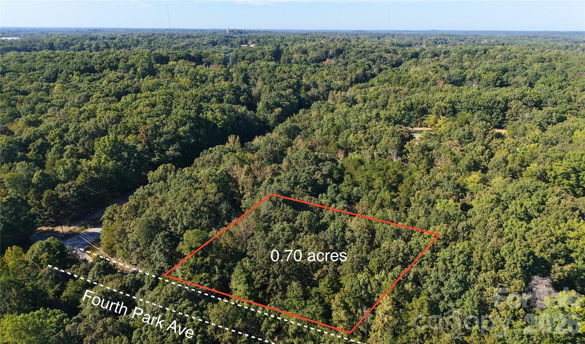 Close drone view of the wooded 0.70 acre lot with the approximate outline along Fourth Park Ave. Lot lines are approximate; no survey. - 00-00 Fourth Park, Randleman