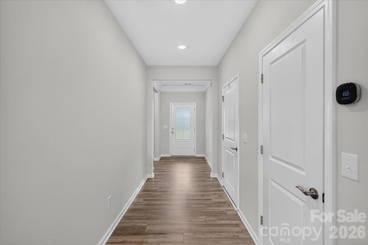 Clean, neutral tones and pristine white trim carry seamlessly down the hall. - 155 White Apple Way, Statesville
