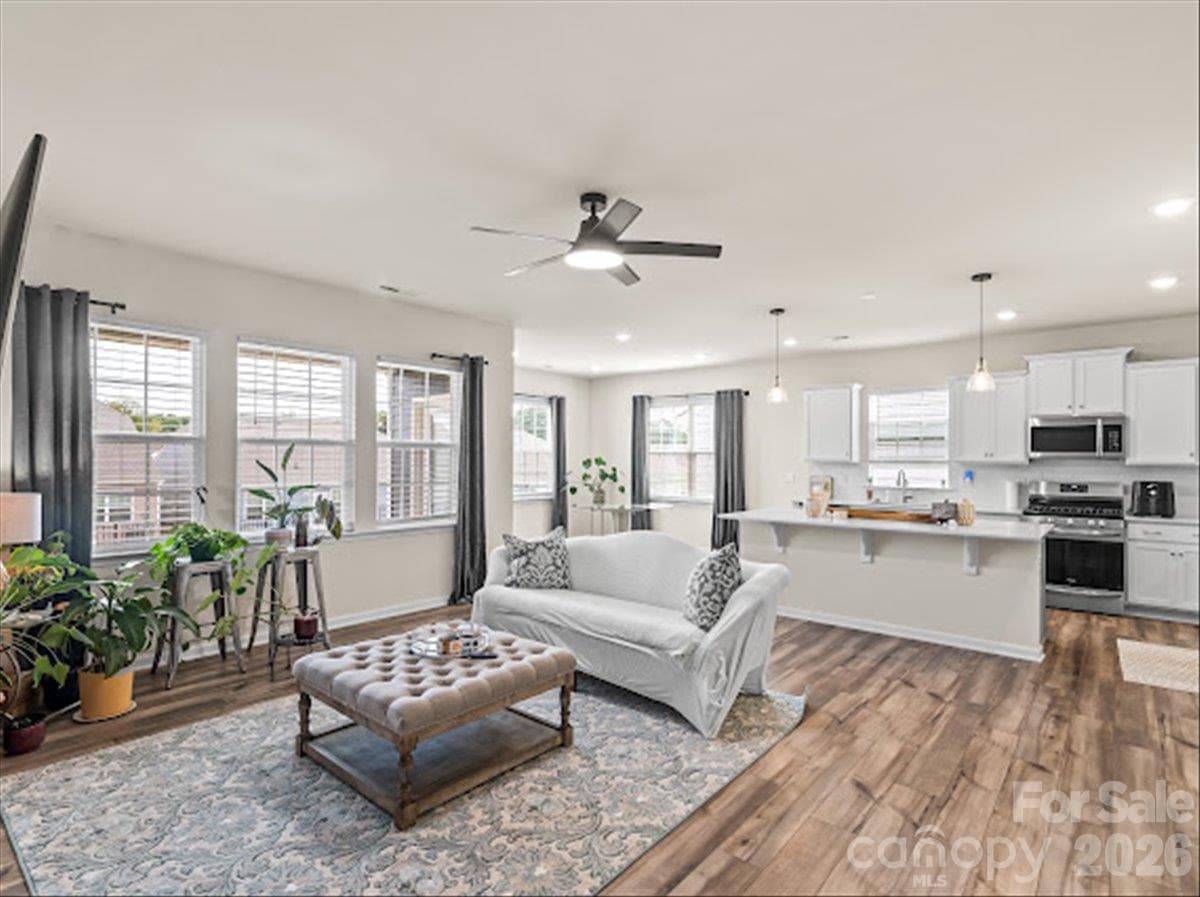 Beautiful open-concept design connecting the spacious living room directly to the stunning kitchen with an island, perfect for entertaining. - 155 White Apple Way, Statesville