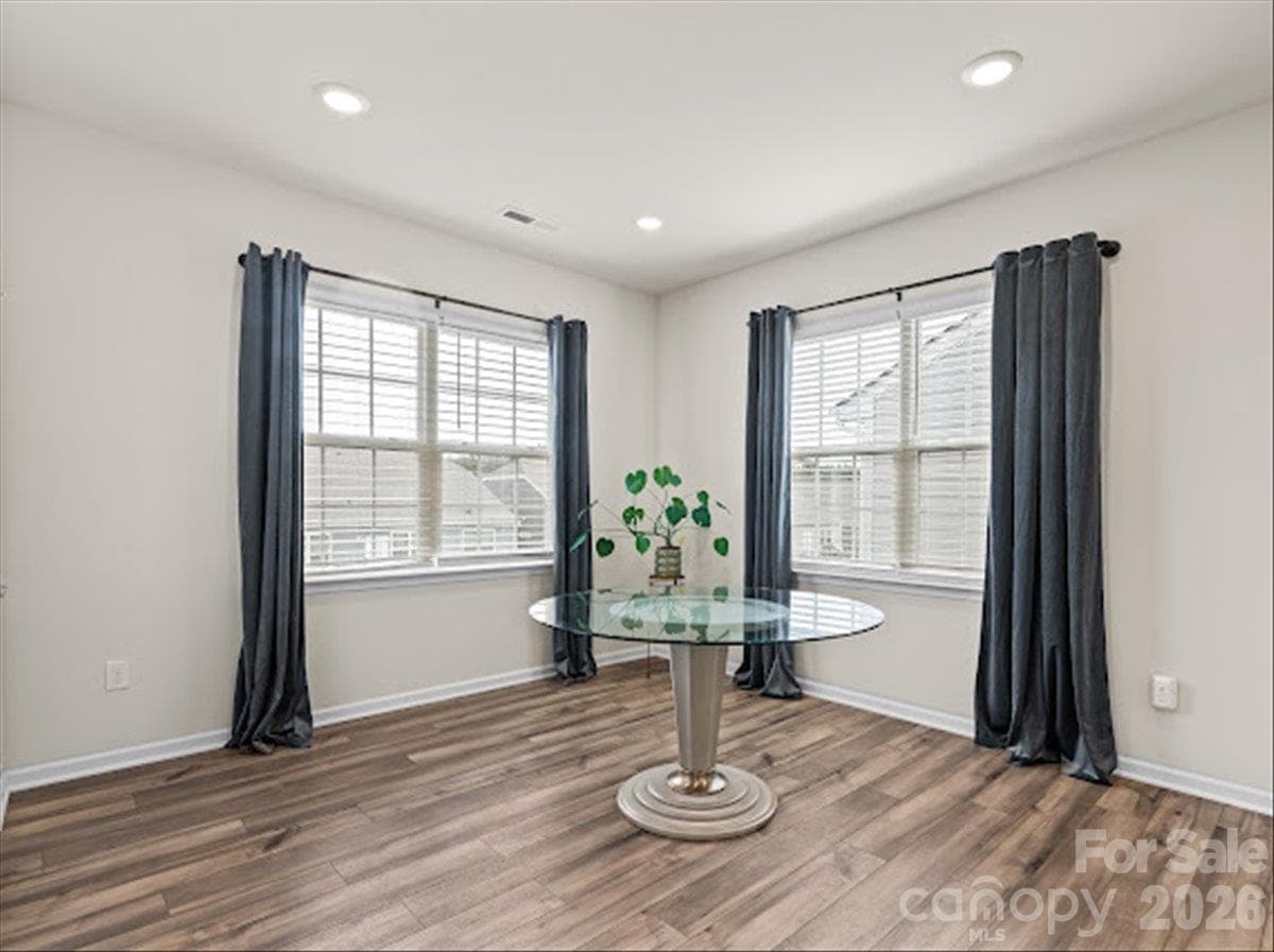Another view of the inviting dining space, offering a perfect setting for meals with a great view of the outdoors. - 155 White Apple Way, Statesville