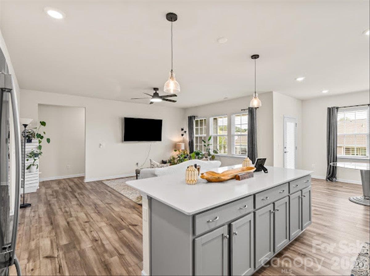 Seamless transition from the dining area to the gorgeous kitchen island, highlighting the home's fantastic open-concept layout - 155 White Apple Way, Statesville