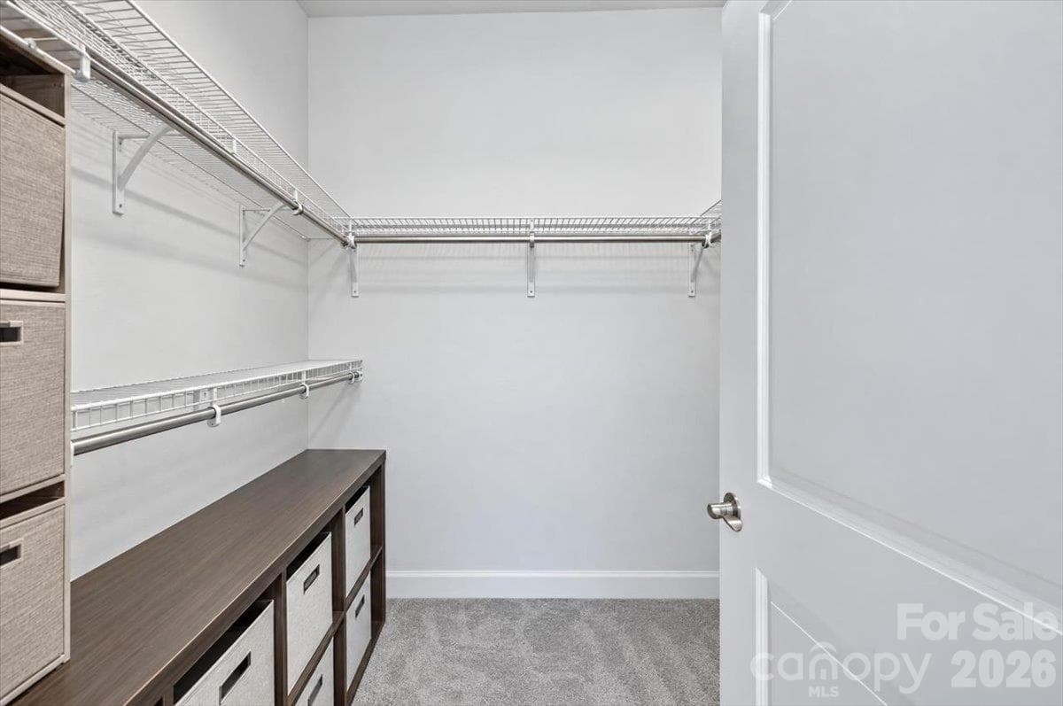Expansive walk-in closet offering fantastic built-in shelving, drawers, and plenty of hanging space - 155 White Apple Way, Statesville