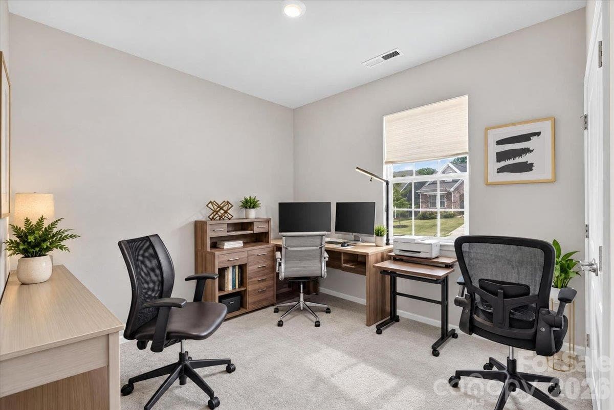Versatile and spacious bedroom, perfectly suited for a home office or guest room, featuring comfortable carpeting and great natural light. - 155 White Apple Way, Statesville