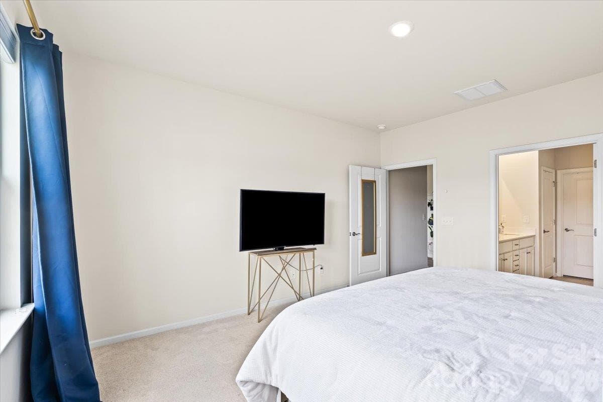 Comfortable primary bedroom offering a great layout with plenty of space for a media setup or additional furnishings. - 155 White Apple Way, Statesville