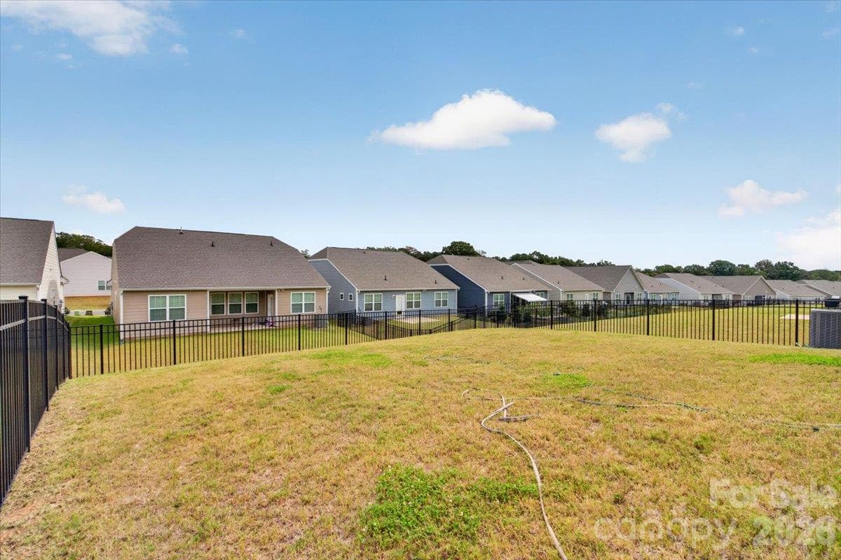 Massive, level, fully fenced-in backyard providing endless possibilities for outdoor living, gardening, and recreation. - 155 White Apple Way, Statesville