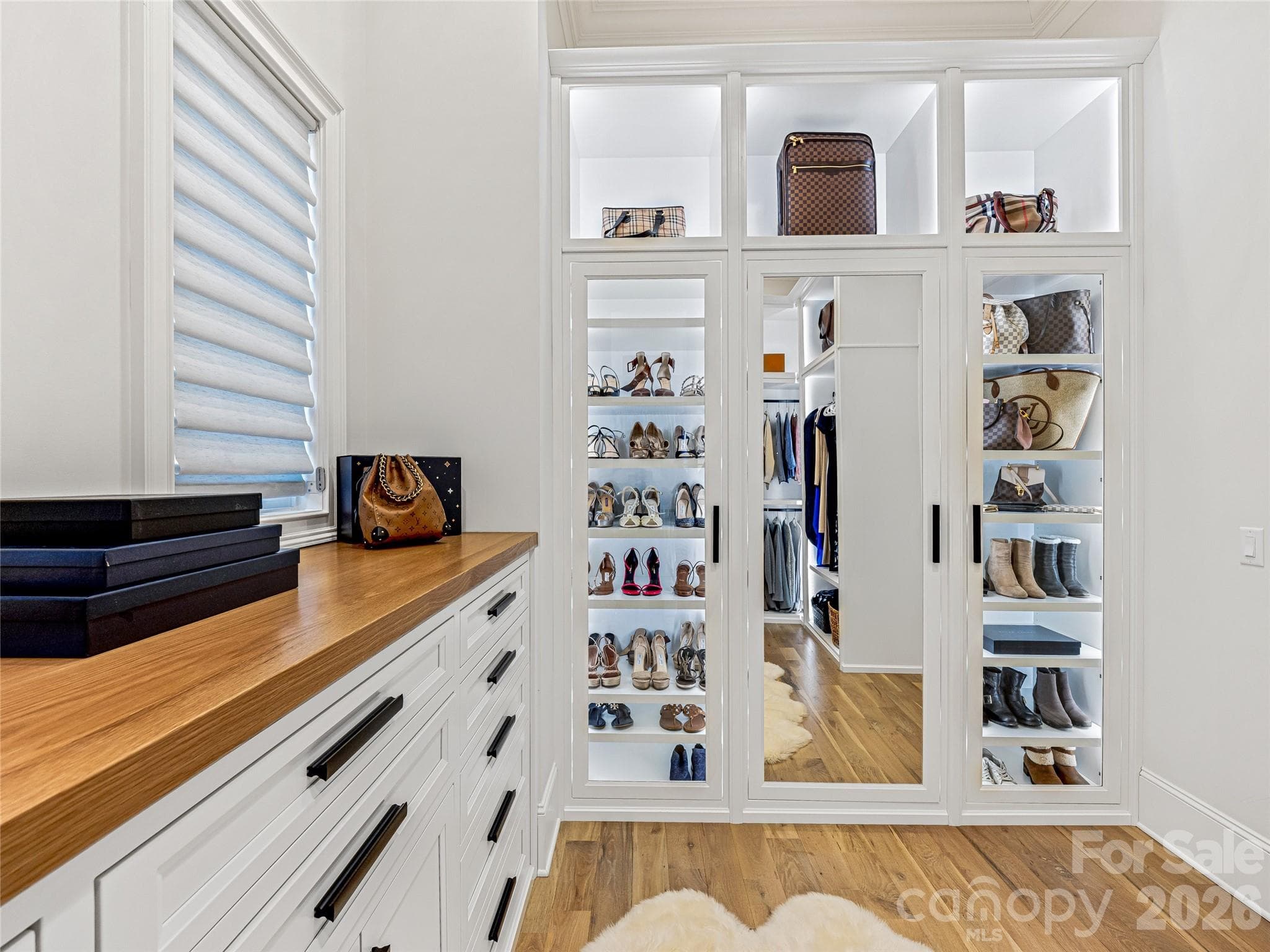 "Hers" Custom Primary Closet. Backlighting, custom shelving. Must See! - 1905 White Tree Trail, Arden