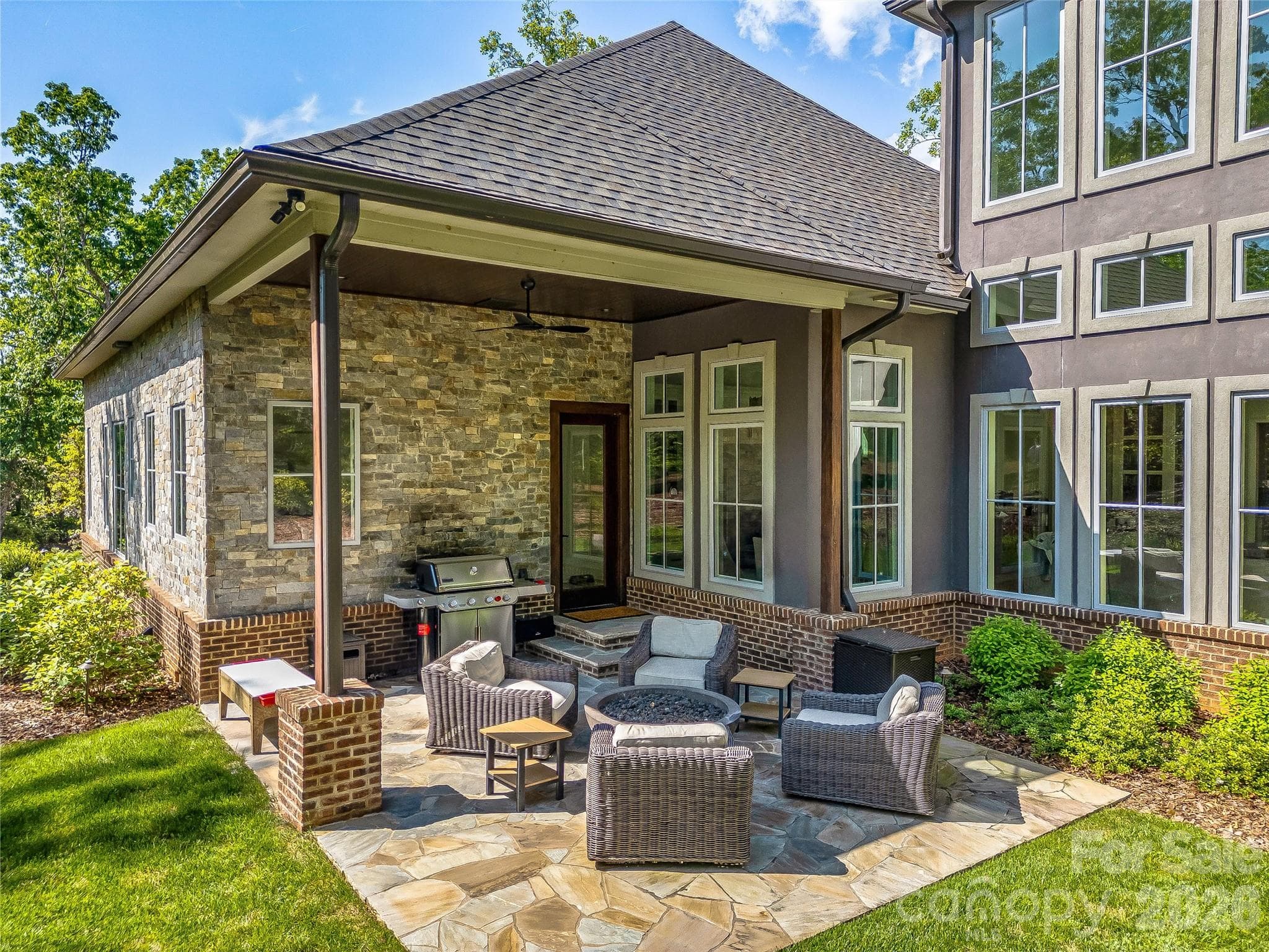 Covered back patio with additional firepit entertaining, grilling area. - 1905 White Tree Trail, Arden