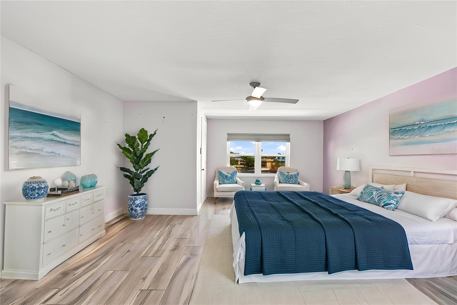The primary bedroom offers enough space for a sitting area, has a private balcony, a walk in closet with an organizing system. Bring your king sized furniture. Virtually staged. - 152 117TH AVE, TREASURE ISLAND