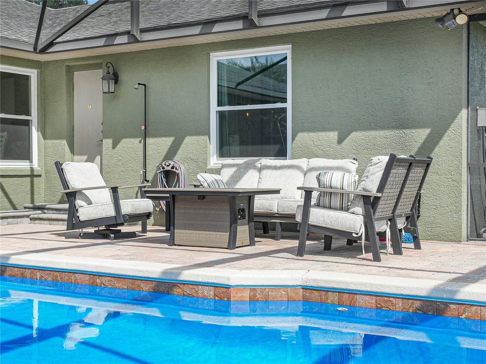 Another sitting area poolside next to door for the pool bathroom - 5868 HIGH RIDGE LOOP, LAKELAND