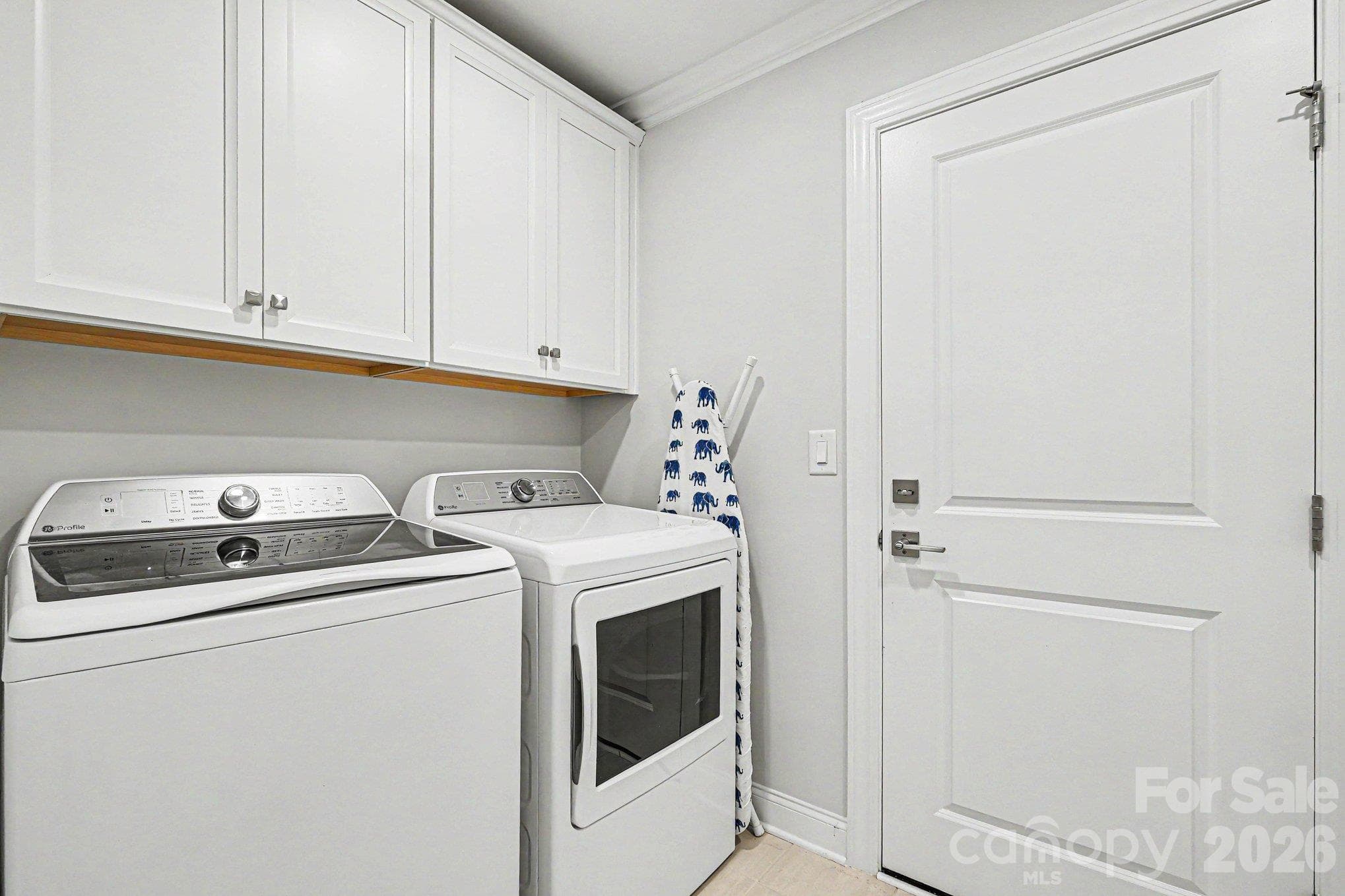 Laundry room with built-in cabinet space - 5605 Caneel Lane, Denver