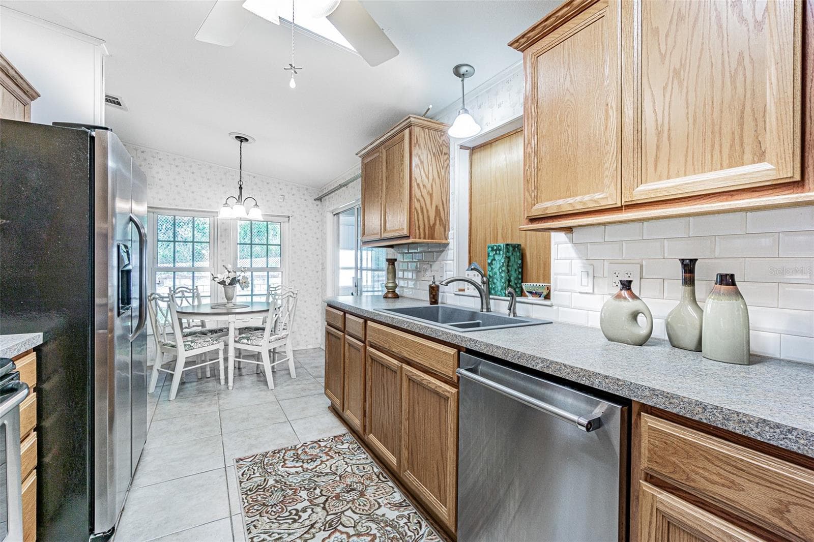 Galley kitchen with loads of cabinets! - 37449 GILL AVE, ZEPHYRHILLS