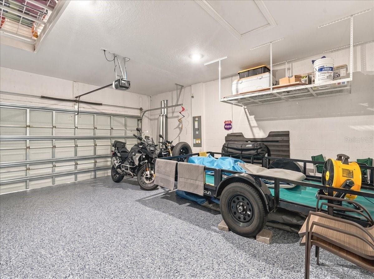 The garage has an epoxy finish along with overhead storage. - 4732 CRESTPOINT WAY, PALMETTO