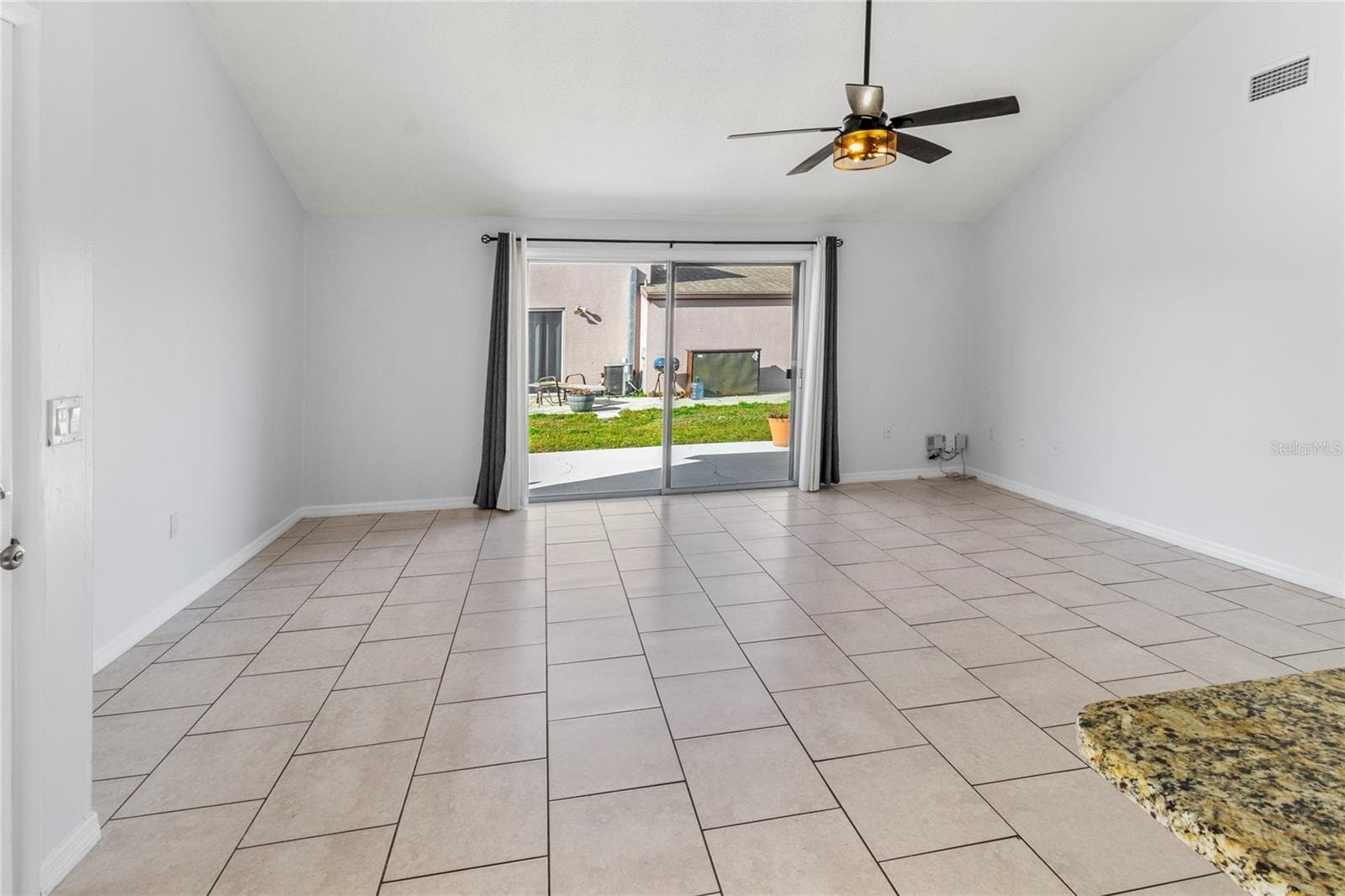 Living Room | There is now a white vinyl fence separating these two homes - so very private now and no more view of the neighbors! - 7013 BRENTFORD RD, SARASOTA
