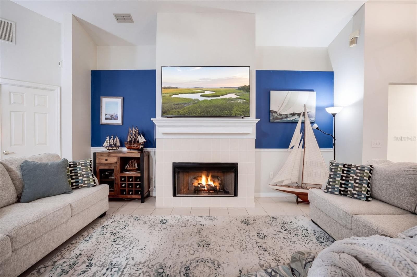 Vaulted ceilings and a wood-burning fireplace create a memorable centerpiece in the main living room. - 71 ORANGE BLOSSOM DR, EUSTIS