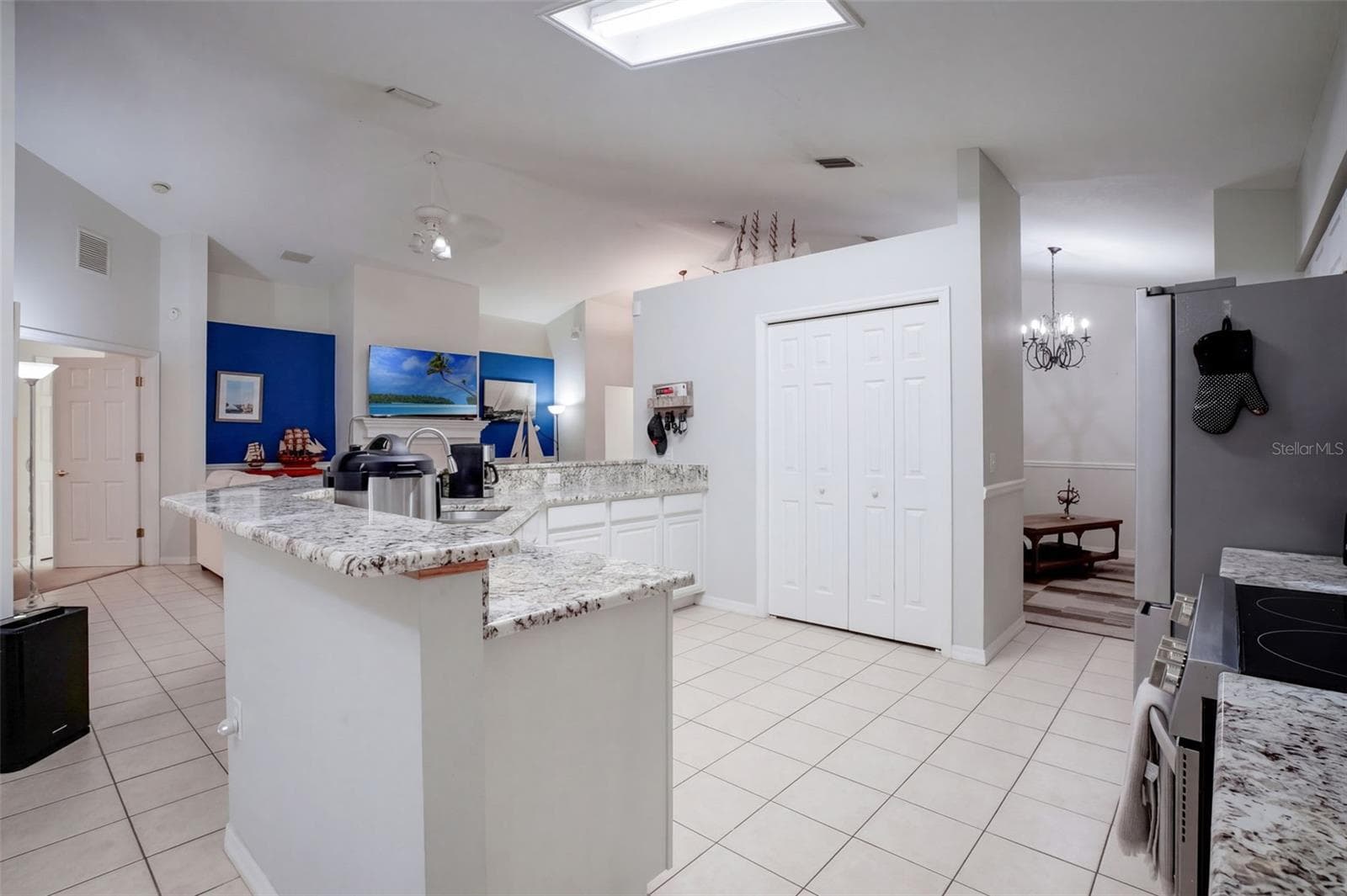 The open layout keeps the kitchen, dining, and living spaces connected. - 71 ORANGE BLOSSOM DR, EUSTIS