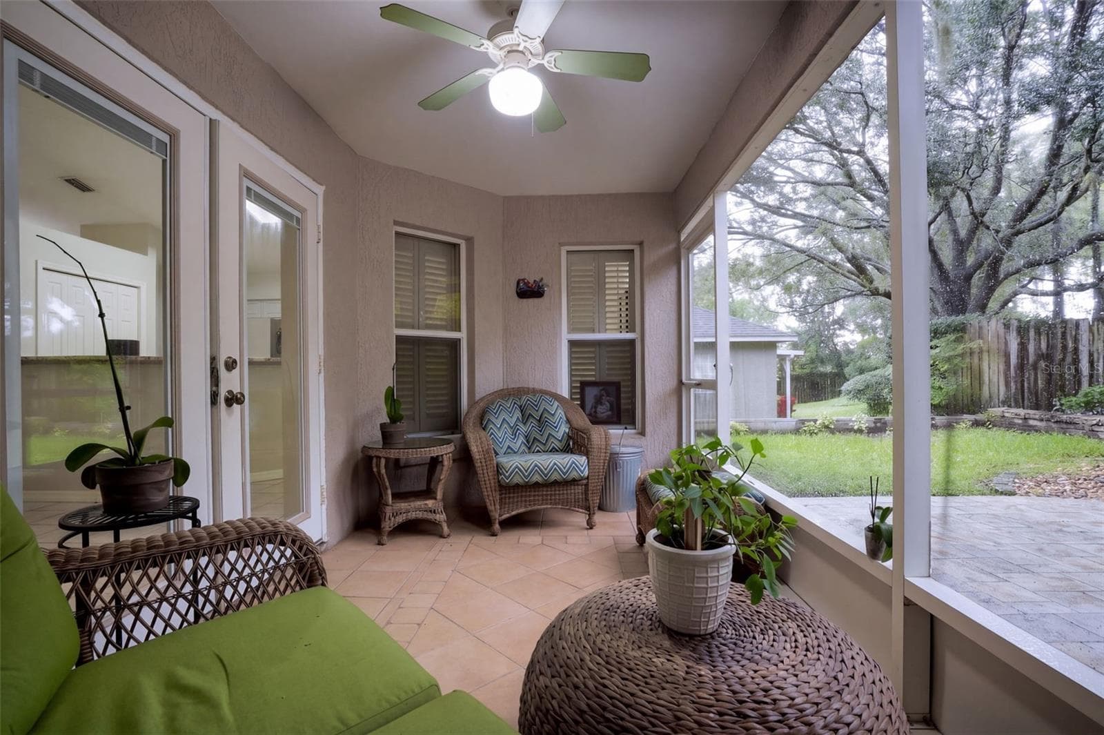 A screened rear porch provides comfortable outdoor living protected from the elements. - 71 ORANGE BLOSSOM DR, EUSTIS