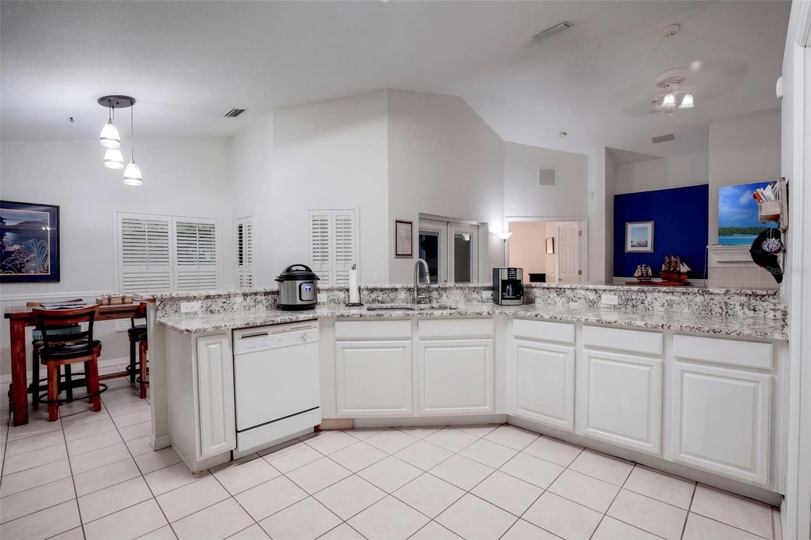 The kitchen offers abundant cabinetry, a wide prep area, and views into the main living spaces. - 71 ORANGE BLOSSOM DR, EUSTIS