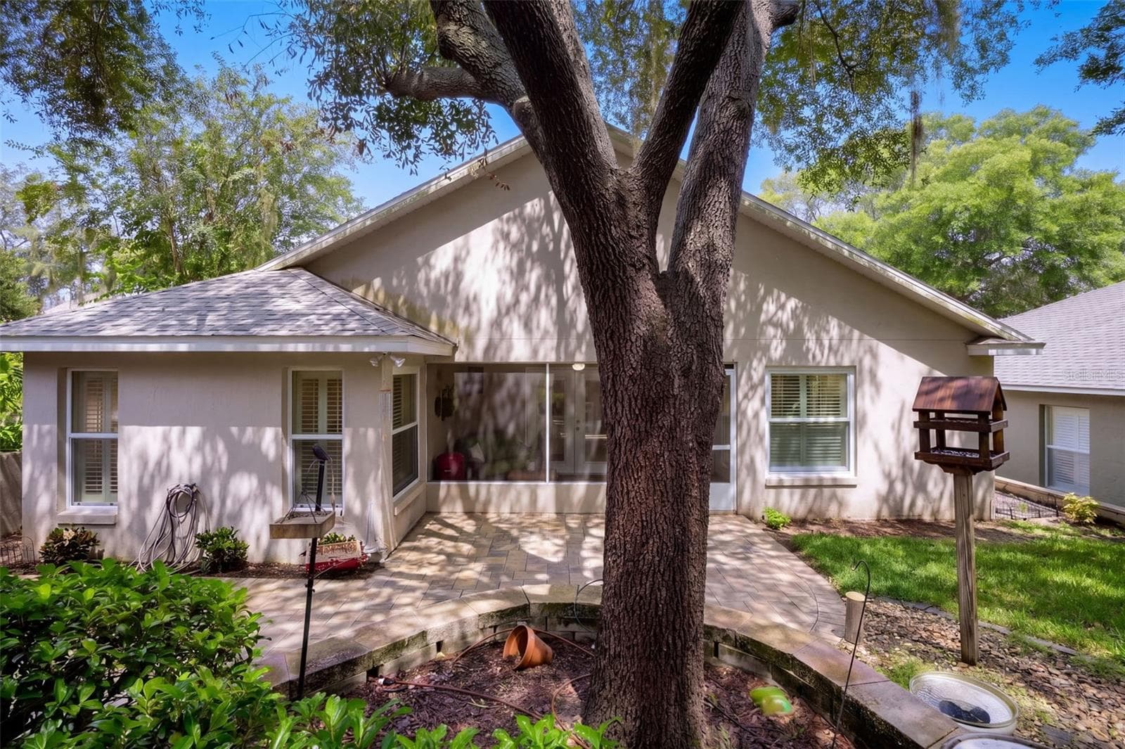 A mature oak anchors the backyard and provides welcome shade. - 71 ORANGE BLOSSOM DR, EUSTIS
