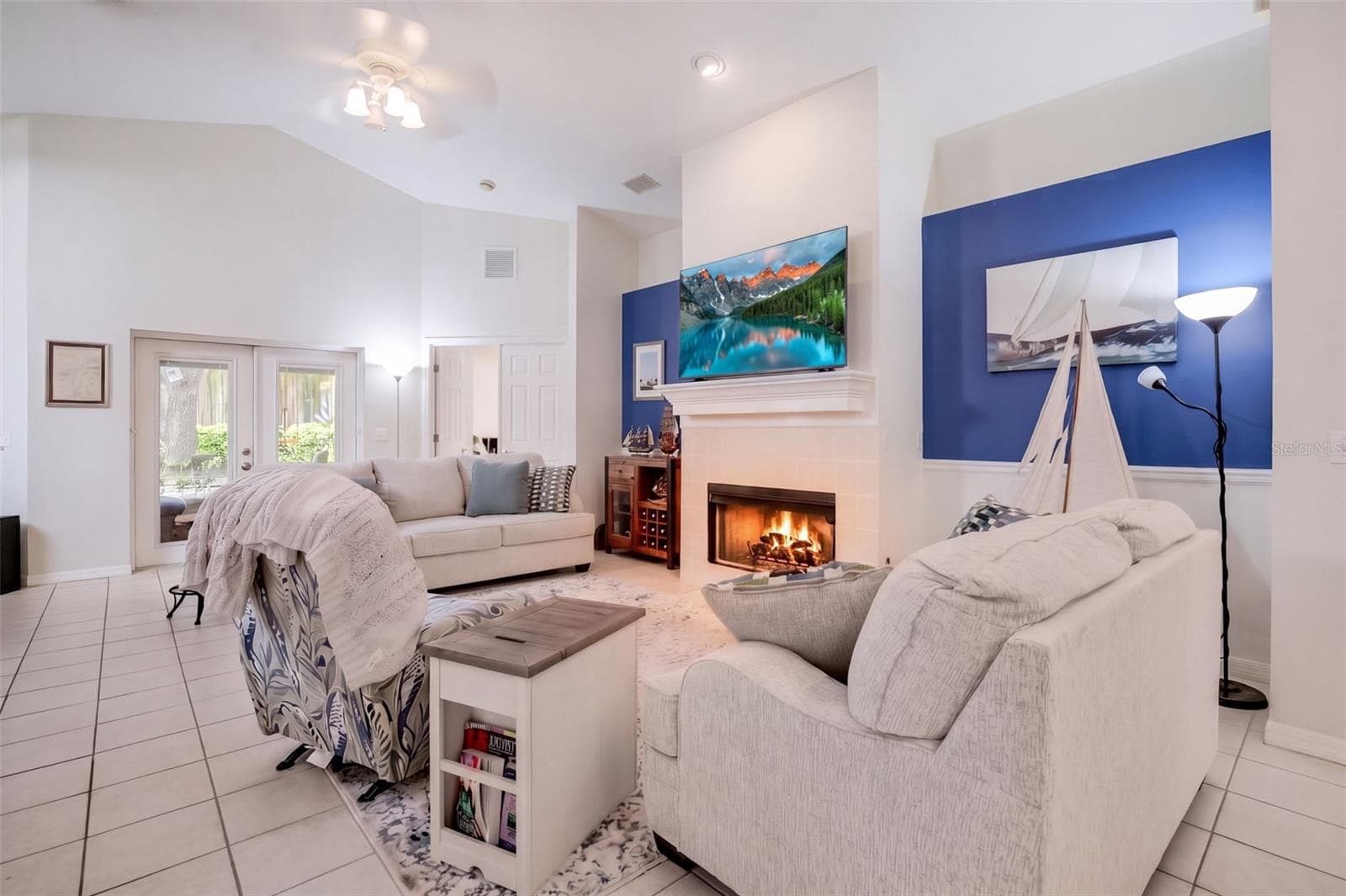 The main living room offers an easy furniture arrangement around the fireplace. - 71 ORANGE BLOSSOM DR, EUSTIS