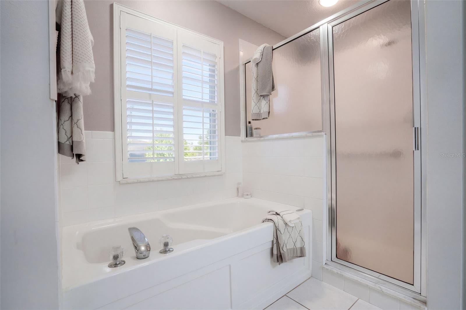 A separate shower and garden tub offer two ways to unwind in the primary bath. - 71 ORANGE BLOSSOM DR, EUSTIS