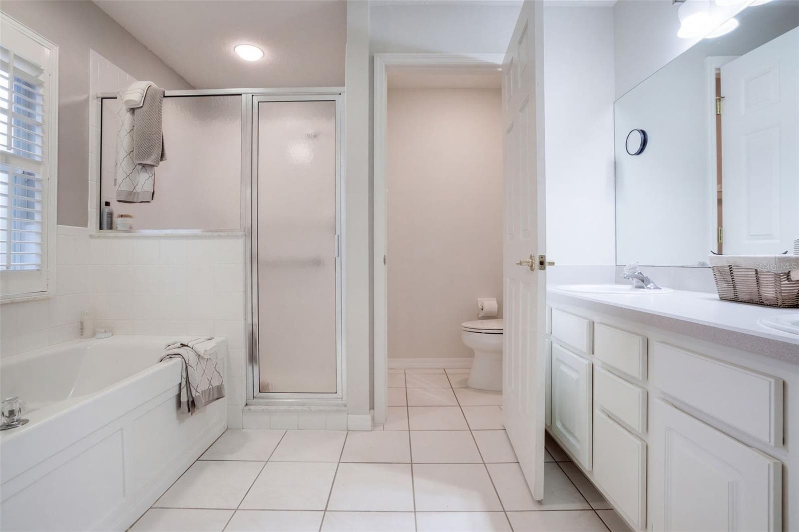 The spacious primary bathroom completes the private suite. - 71 ORANGE BLOSSOM DR, EUSTIS