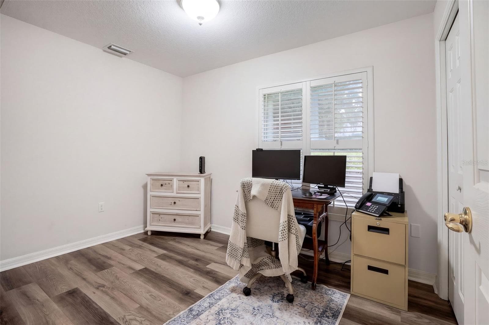 The third bedroom is currently arranged as a home office and hobby space. - 71 ORANGE BLOSSOM DR, EUSTIS