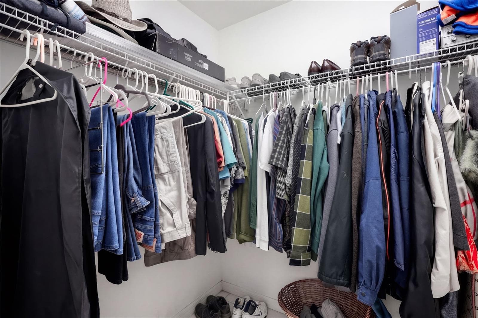 A walk-in closet provides organized storage for clothing and accessories. - 71 ORANGE BLOSSOM DR, EUSTIS