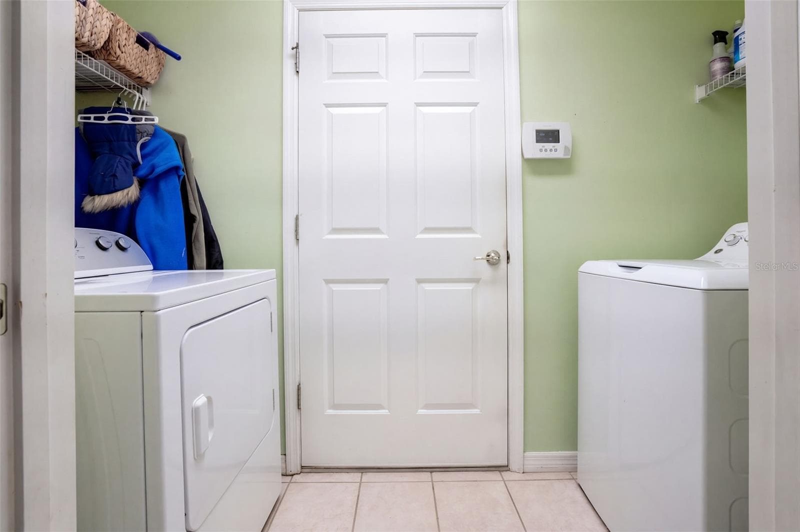 The interior laundry room keeps daily chores conveniently inside. - 71 ORANGE BLOSSOM DR, EUSTIS