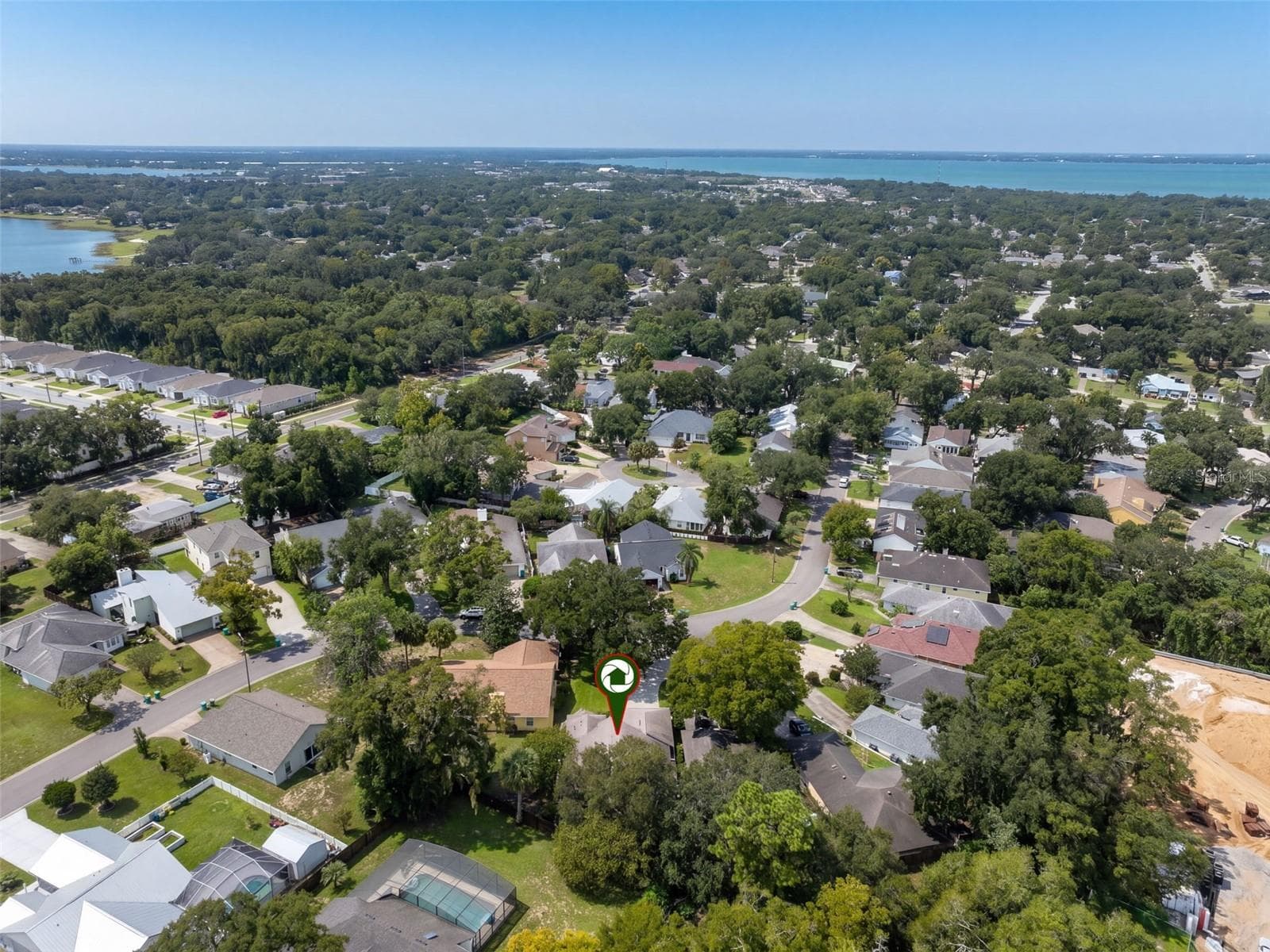 A wider aerial view places the home within the neighborhood. - 71 ORANGE BLOSSOM DR, EUSTIS