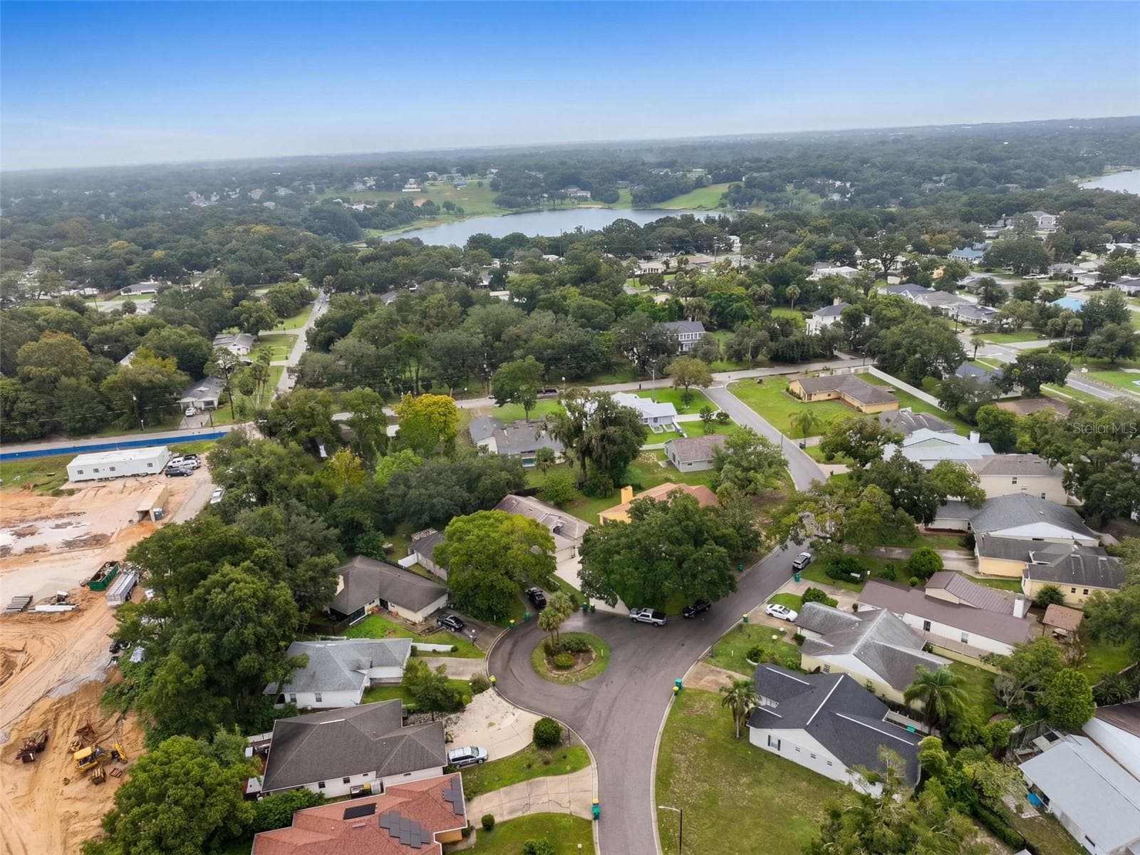 A final neighborhood overview highlights the area's tree cover and nearby water. - 71 ORANGE BLOSSOM DR, EUSTIS