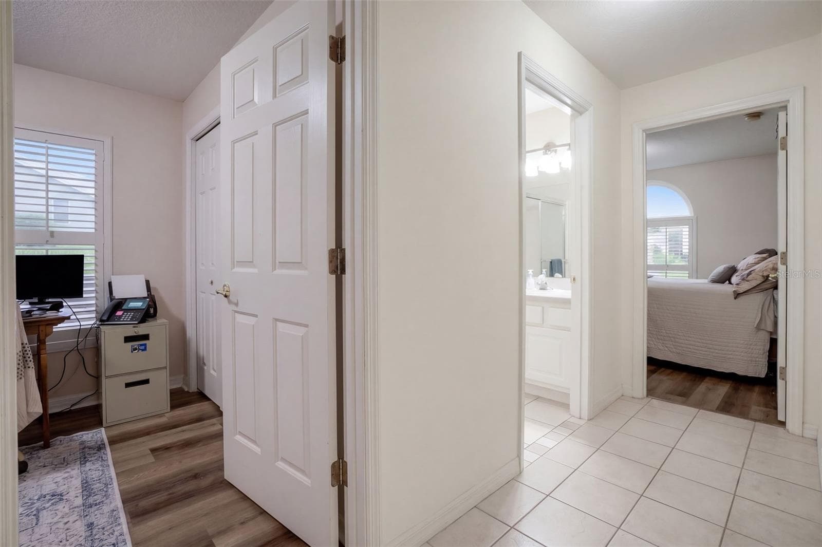 The bedroom hallway creates a practical separation between private and shared spaces. - 71 ORANGE BLOSSOM DR, EUSTIS