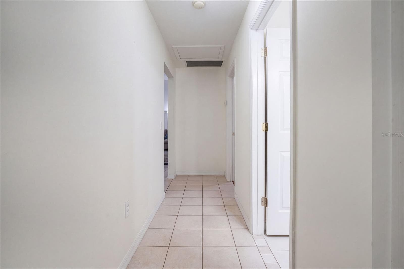 The central hallway provides efficient access among the bedrooms, baths, and living areas. - 71 ORANGE BLOSSOM DR, EUSTIS