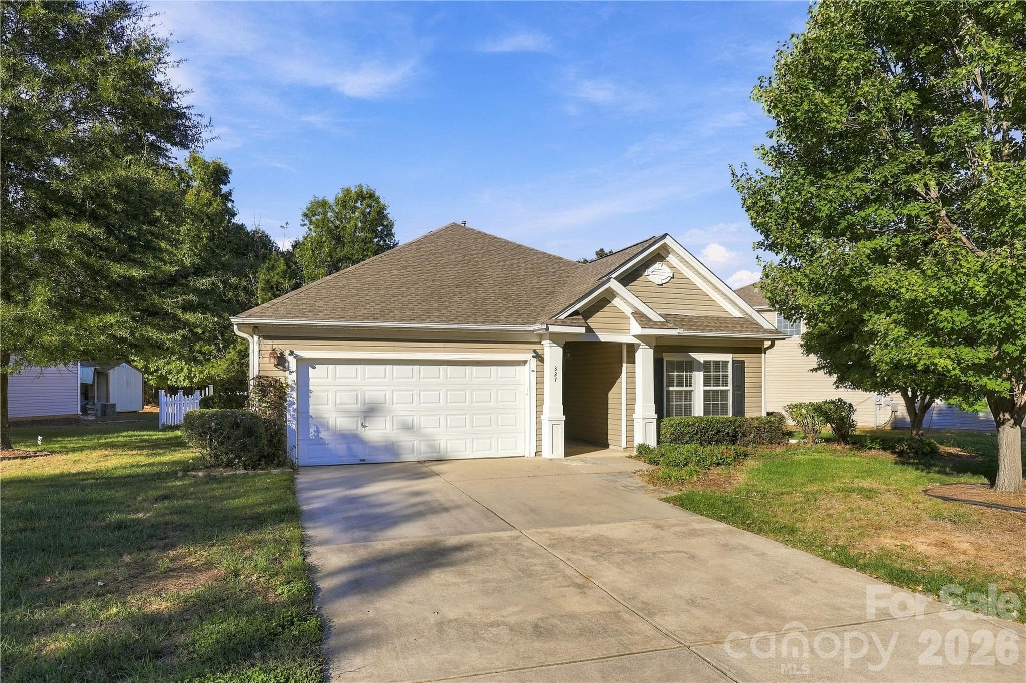 Classic ranch style framed by mature trees, giving the home a peaceful, established feel. - 327 Annaberg Lane, Monroe