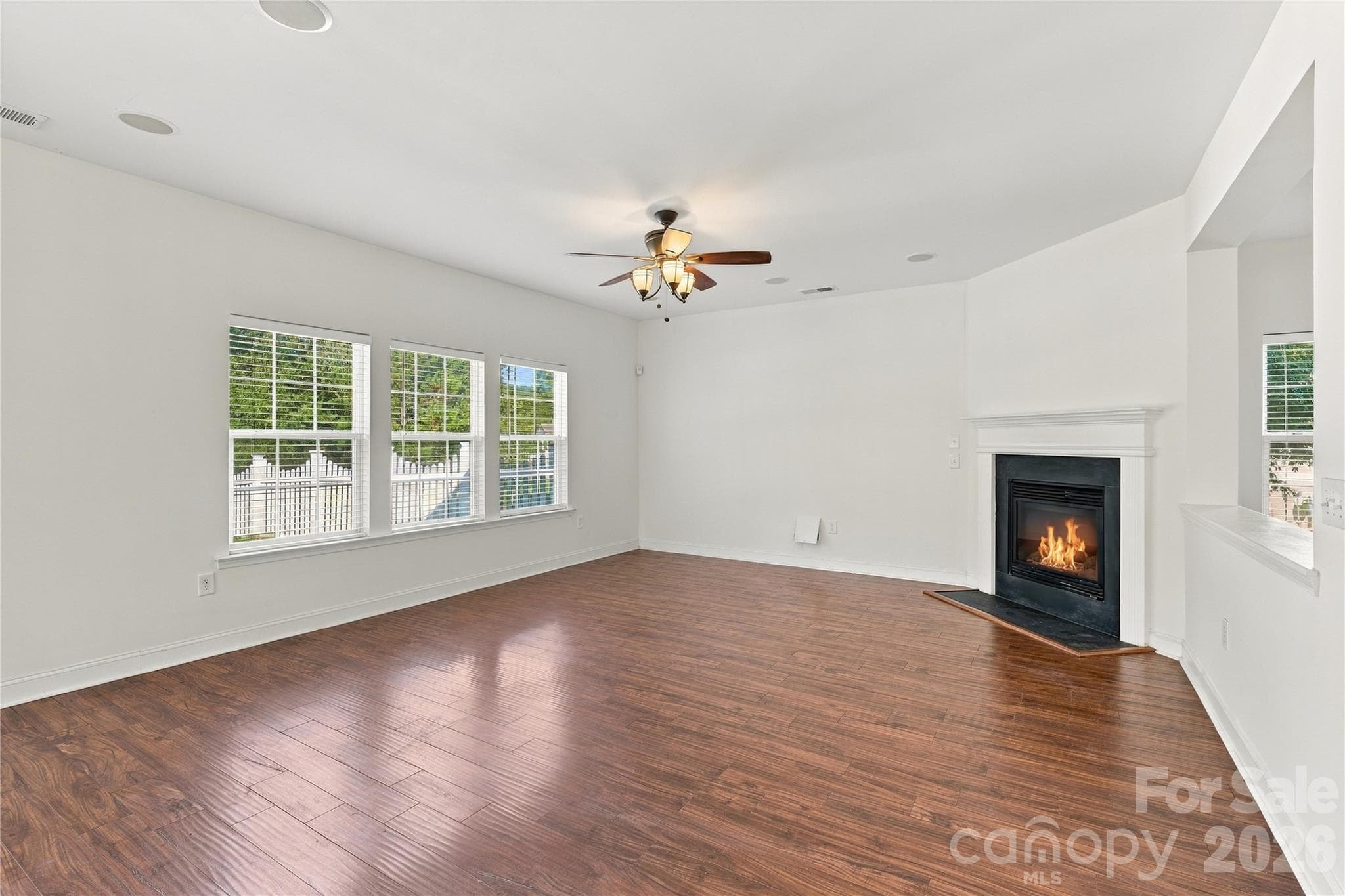 The fireplace anchors the living room, with plenty of space to arrange your furniture. - 327 Annaberg Lane, Monroe