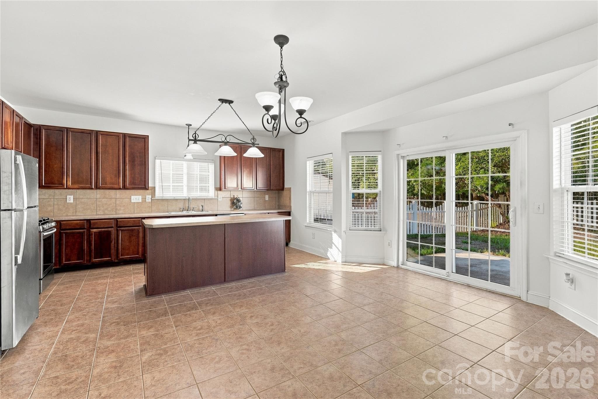 The kitchen and breakfast area sit side by side, with a slider leading out to the backyard. - 327 Annaberg Lane, Monroe