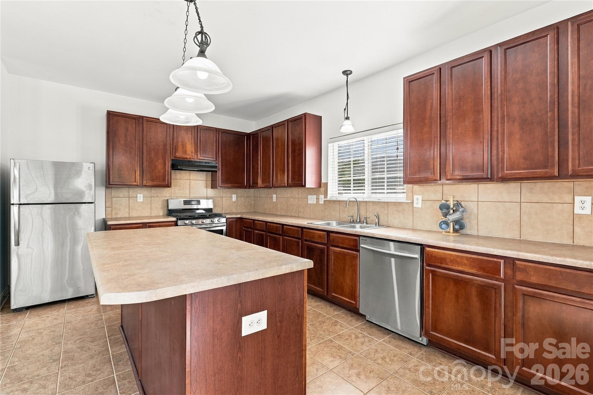 Stainless appliances, pendant lighting, and loads of counter space make this kitchen ready for real life. - 327 Annaberg Lane, Monroe