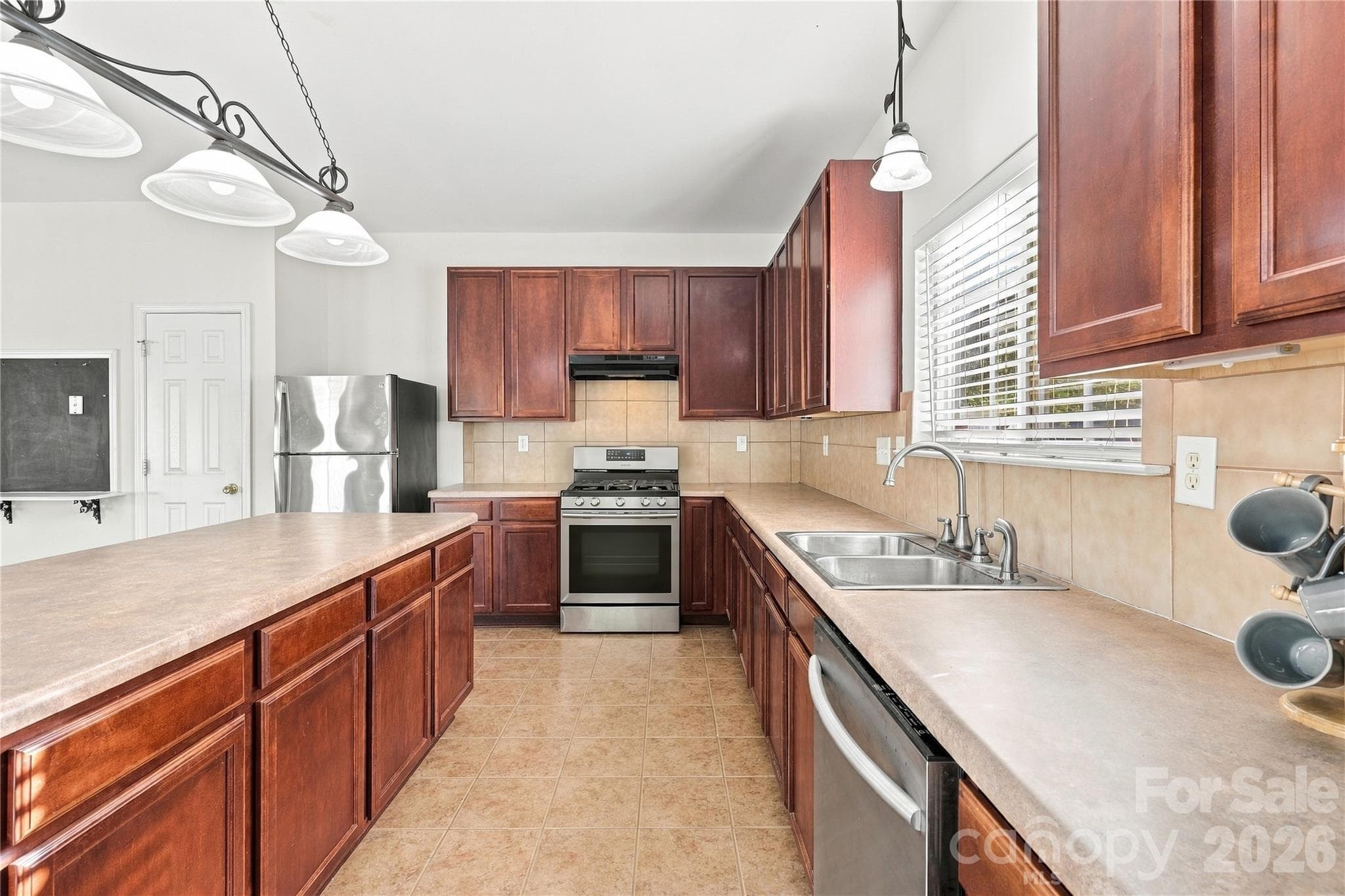 The sink sits under a window, surrounded by plenty of cabinets and counter space. - 327 Annaberg Lane, Monroe